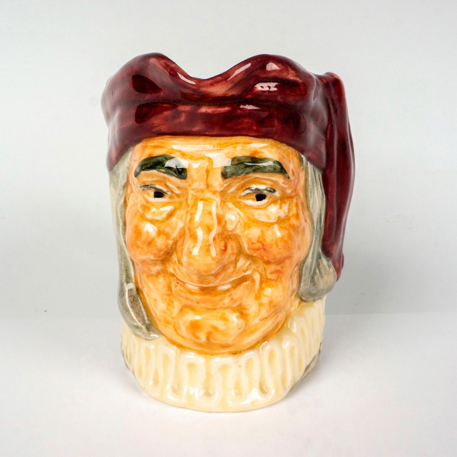 Royal Doulton Small Character Jug, Simon Cellar D5616: Souvenir From Bentalls backstamp. Hand painted in maroon, white and grey coloration. Royal Doulton backstamp. Artist: Charles Noke Issued: 1936 Dimensions: 2.25"L x 4"W x 3.5"H Manufacturer: Royal Dou