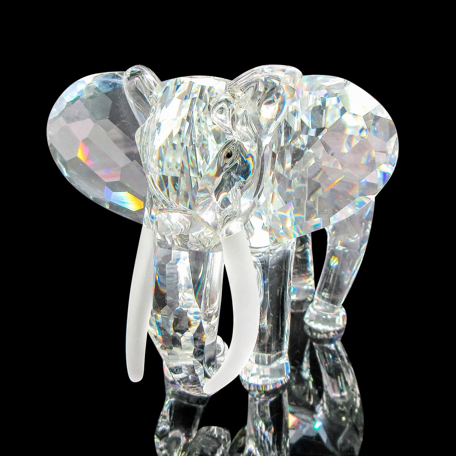 Swarovski Silver Crystal Figurine, The Elephant: The first figure of the Inspiration Africa trilogy. Clear crystal faceted body with black eyes and frosted tusks. Swarovski backstamp. Artist: Martin Zendron Issued: 1993 Dimensions: 4.75"L x 3.5"W x 