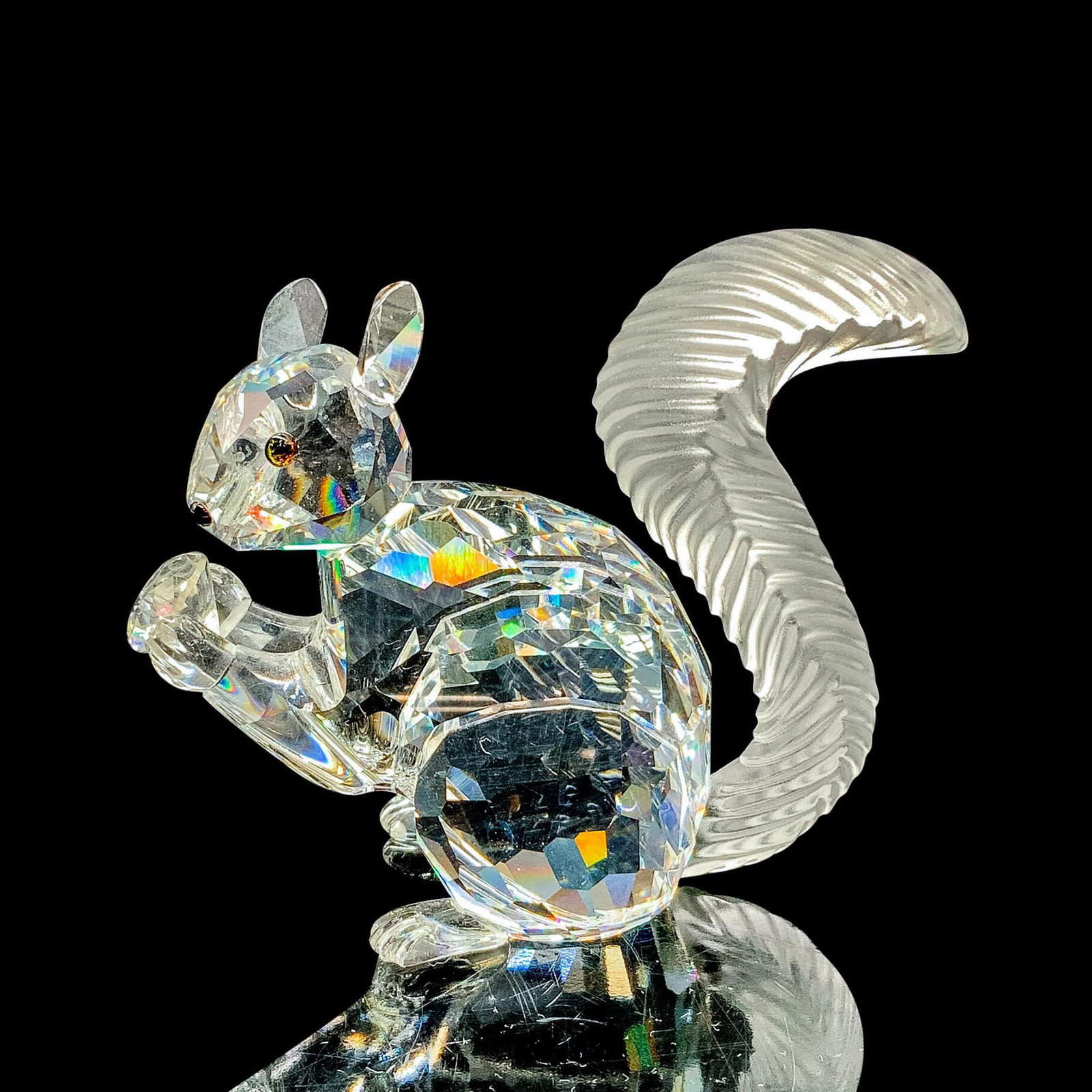 Swarovski Crystal Figurine, SCS Squirrel 208433: This limited edition Swarovski Crystal Society squirrel was issued to celebrate the 10th anniversary of the SCS. The squirrel is made from clear crystal, and has a frosted tail. It holds a crystal cha