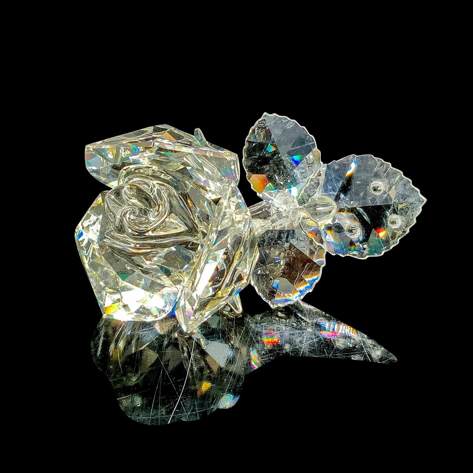 Swarovski Crystal Figurine, Rose 174956: This retired Swarovski crystal rose was part of the In the Secret Garden theme group and is made from clear faceted crystal. Swarovski backstamp. Artist: Michael Stamey Issued: 1993-2007 Dimensions: 3