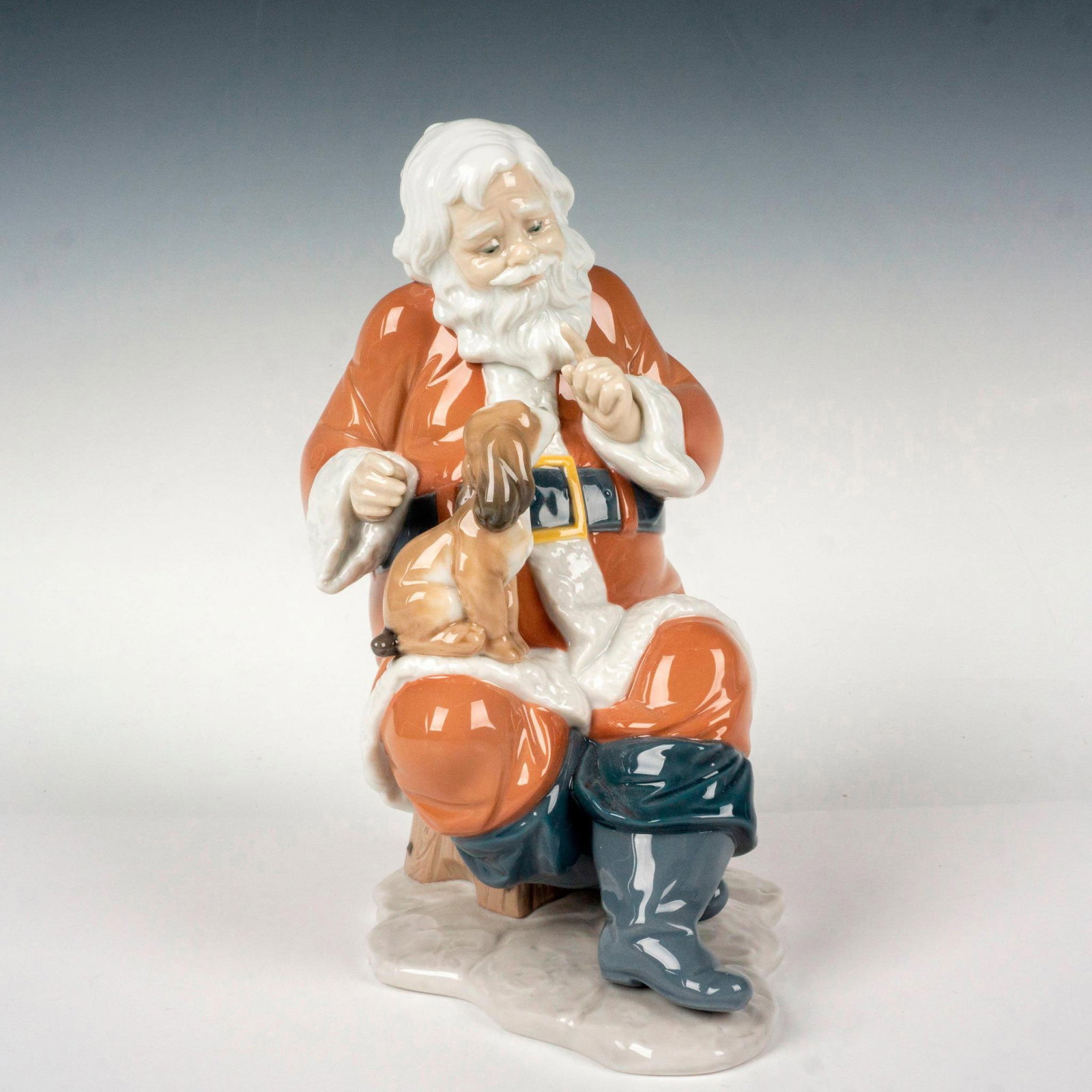 Santa's Little Secret 1006890 - Lladro Porcelain Figurine: Glossy finish; Lladro backstamp. Includes original box. Box measures: 9.5"L x 8"W x 13.75"H. Artist: Virginia Gonzalez Issued: 2002 - 2013 Dimensions: 9"H x 5"W Manufacturer: Lladro Country of Origin: