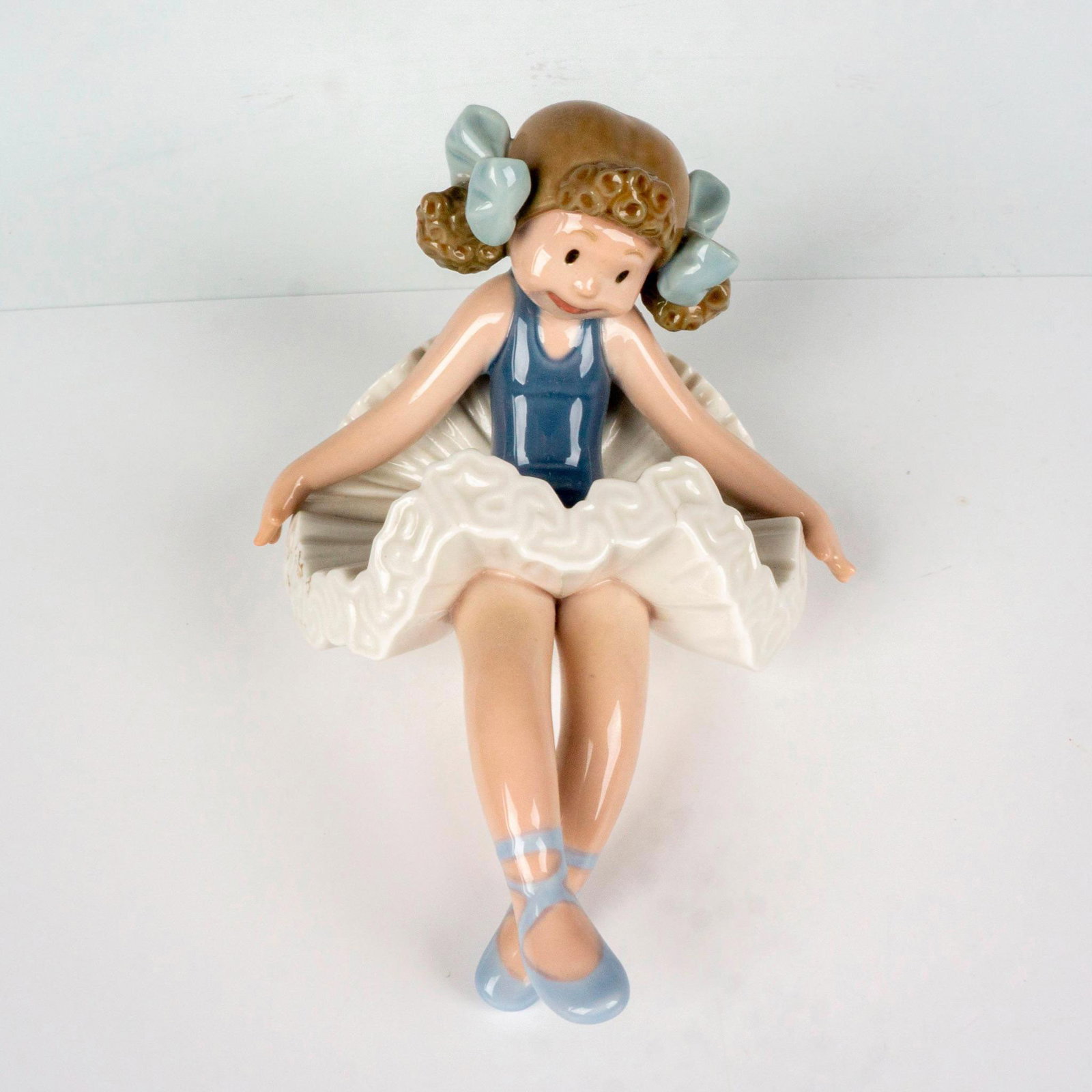 Rag Doll 1001501 - Lladro Porcelain Figurine: Glossy finish; Lladro backstamp. Artist: Jose Puche Issued: 1985-1991 Dimensions: 4.25"L x 6"W x 4.5"H Manufacturer: Lladro Country of Origin: Spain