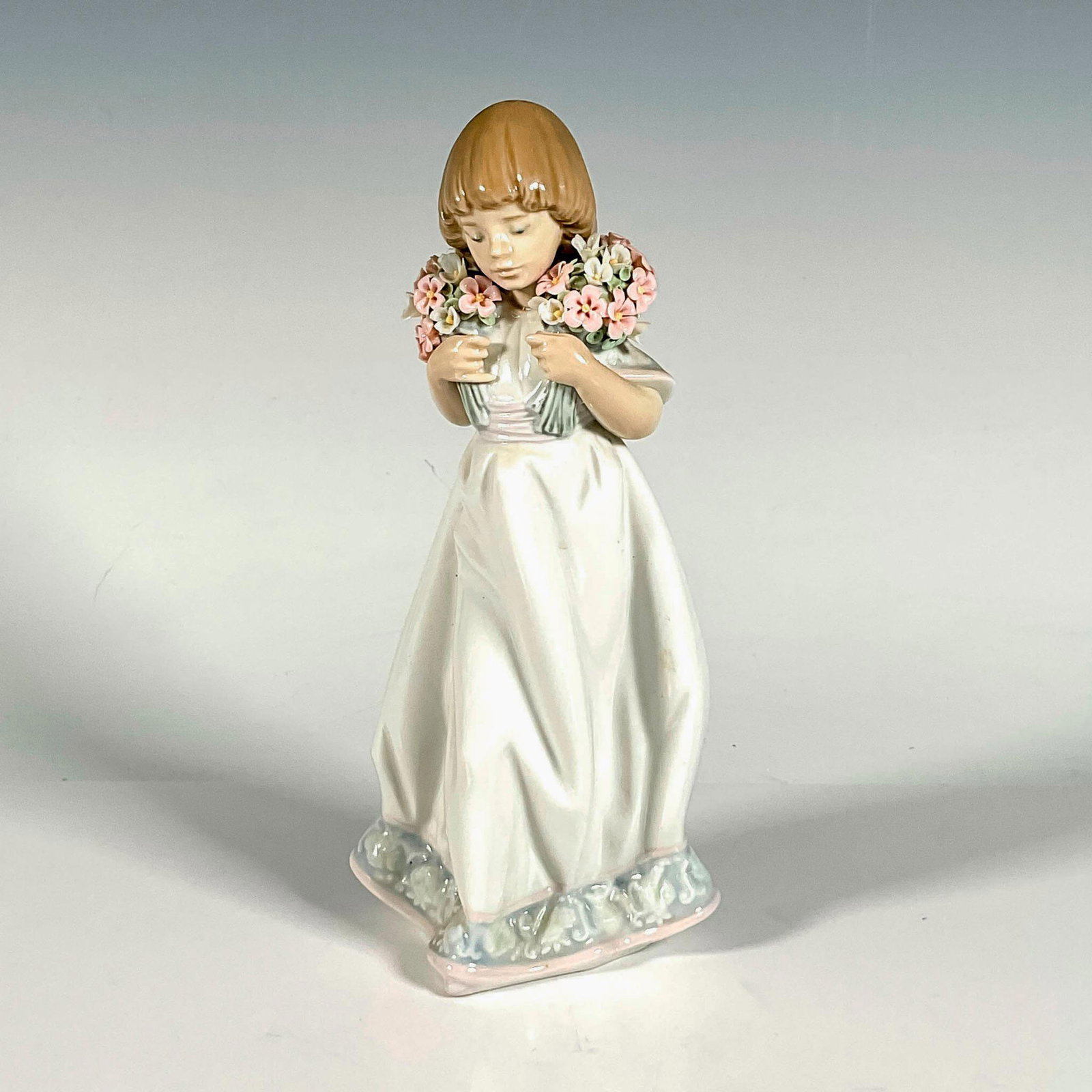 Spring Bouquets 1007603 - Lladro Porcelain Figurine: Glossy finish; Lladro backstamp. Includes original box. Box measures: 12.5"L x 7.5"W x 6"H. Artist: Juan Huerta Issued: 1987 - 1987 Dimensions: 8.75"H x 3.5"W Manufacturer: Lladro Country of Origin:</