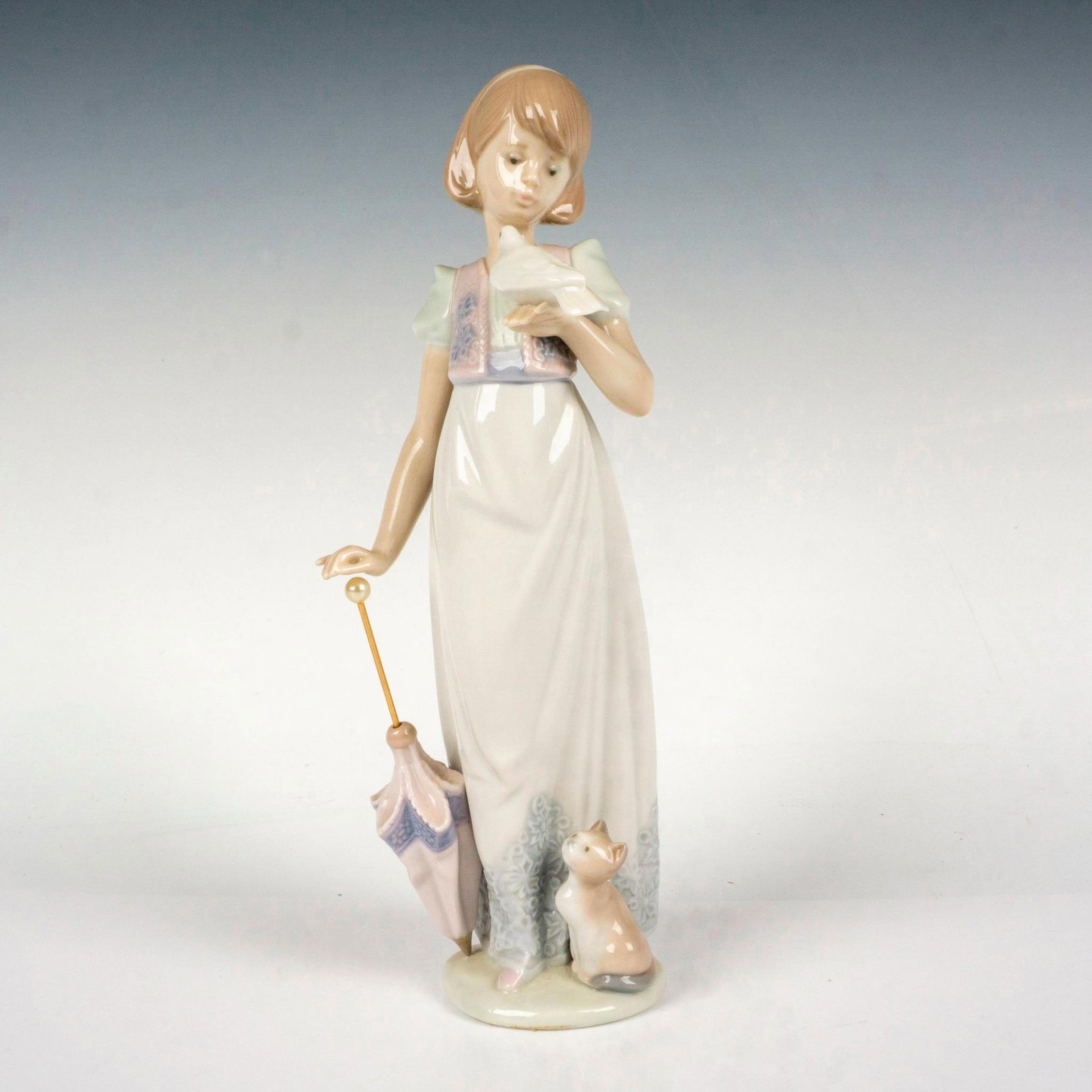 Summer Stroll 1007611 - Lladro Porcelain Figurine: Glossy finish; Lladro backstamp. Includes original box. Box measures: 11.5"L x 6"W x 5"H. Artist: Juan Huerta Issued: 1991 - 1991 Dimensions: 9.5"H x 3.25"W Manufacturer: Lladro Country of Origin: