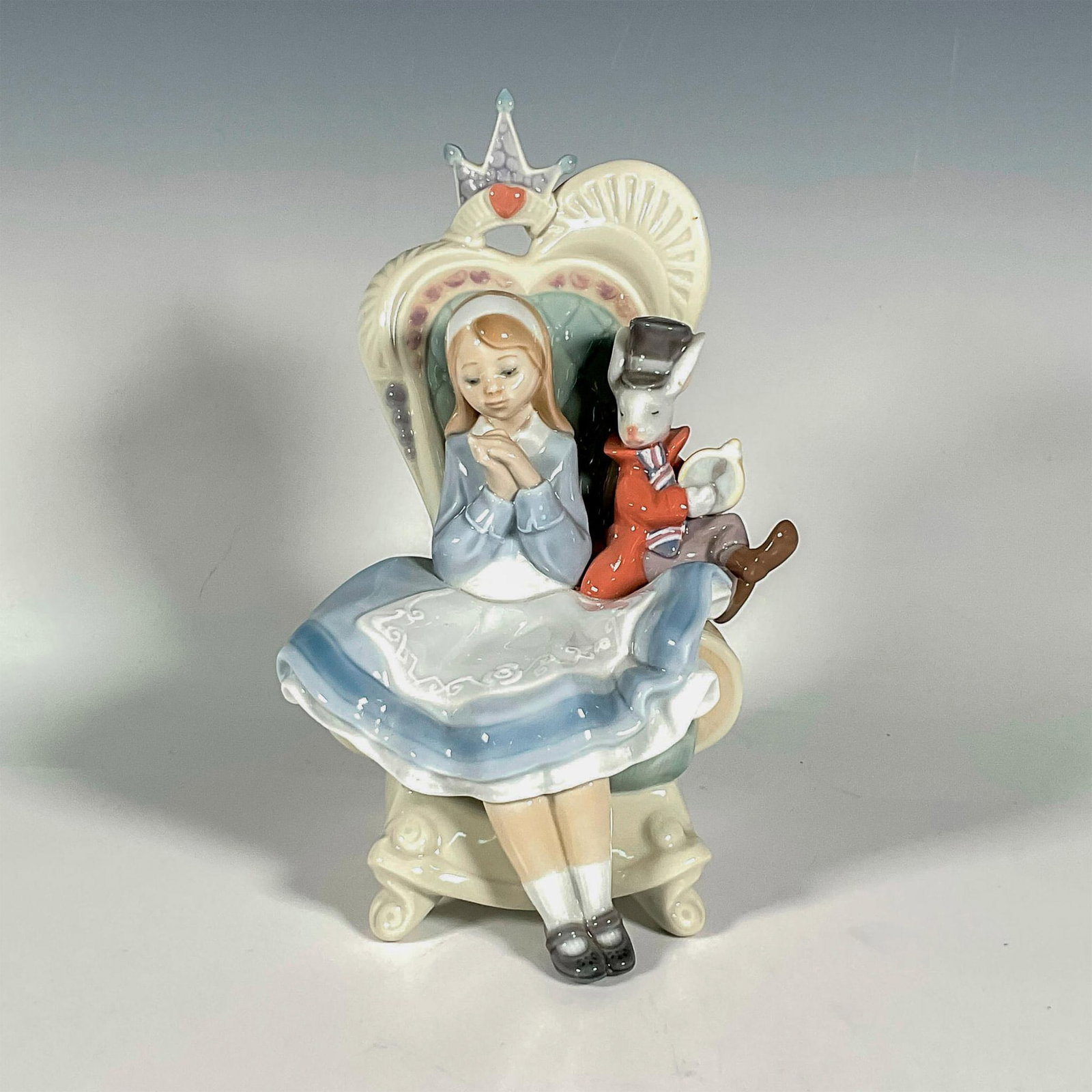 Alice In Wonderland 1008350 - Lladro Porcelain Figurine: Glossy finish; Lladro backstamp. Includes original box. Box measures: 7.5"L x 10"W x 12"H. Artist: Francisco Polope Issued: 2009 Dimensions: 8.25"H x 5"W Manufacturer: Lladro Country of Origin: Sp