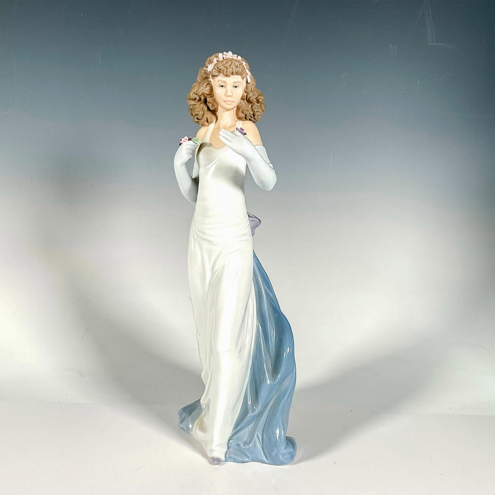 Anticipation 1006608 - Lladro Porcelain Figurine: Glossy finish; Lladro backstamp. Includes original box. Box measures: 17"L x 7.75"W x 7"H. Artist: Regino Torrijos Issued: 1999 - 1999 Dimensions: 12.25"H x 4.75"W Manufacturer: Lladro Country of Orig