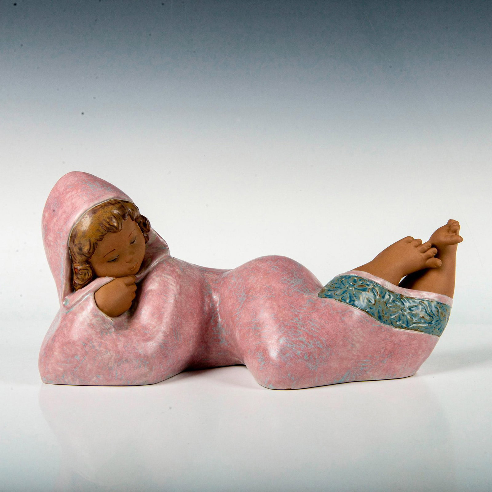 Dreaming of Peace 1012455 - Lladro Porcelain Figurine: Gres finish, modeled as a young girl resting. Lladro backstamp. Artist: Francisco Polope Issued: 2003-2008 Dimensions: 14.5"L x 8"W x 7.5"H Manufacturer: Lladro Country of Origin: Spain