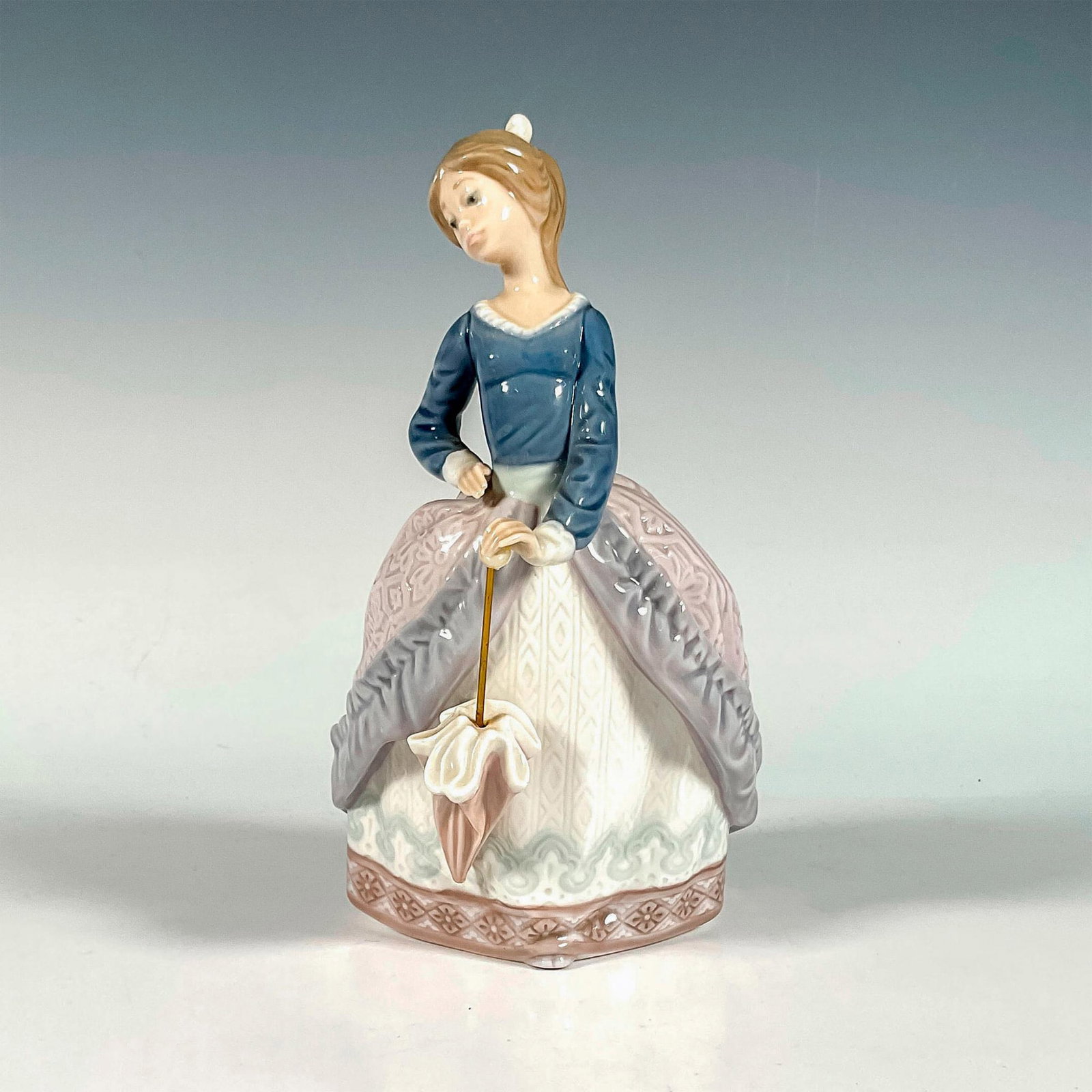 Evita 1005212 - Lladro Porcelain Figurine: Glossy finish; Lladro backstamp. Includes original box. Box measures: 12.5"L x 7.5"W x 6"H. Artist: Jose Puche Issued: 1984 - 1998 Dimensions: 7"H x 4"W Manufacturer: Lladro Country of Origin: Spa
