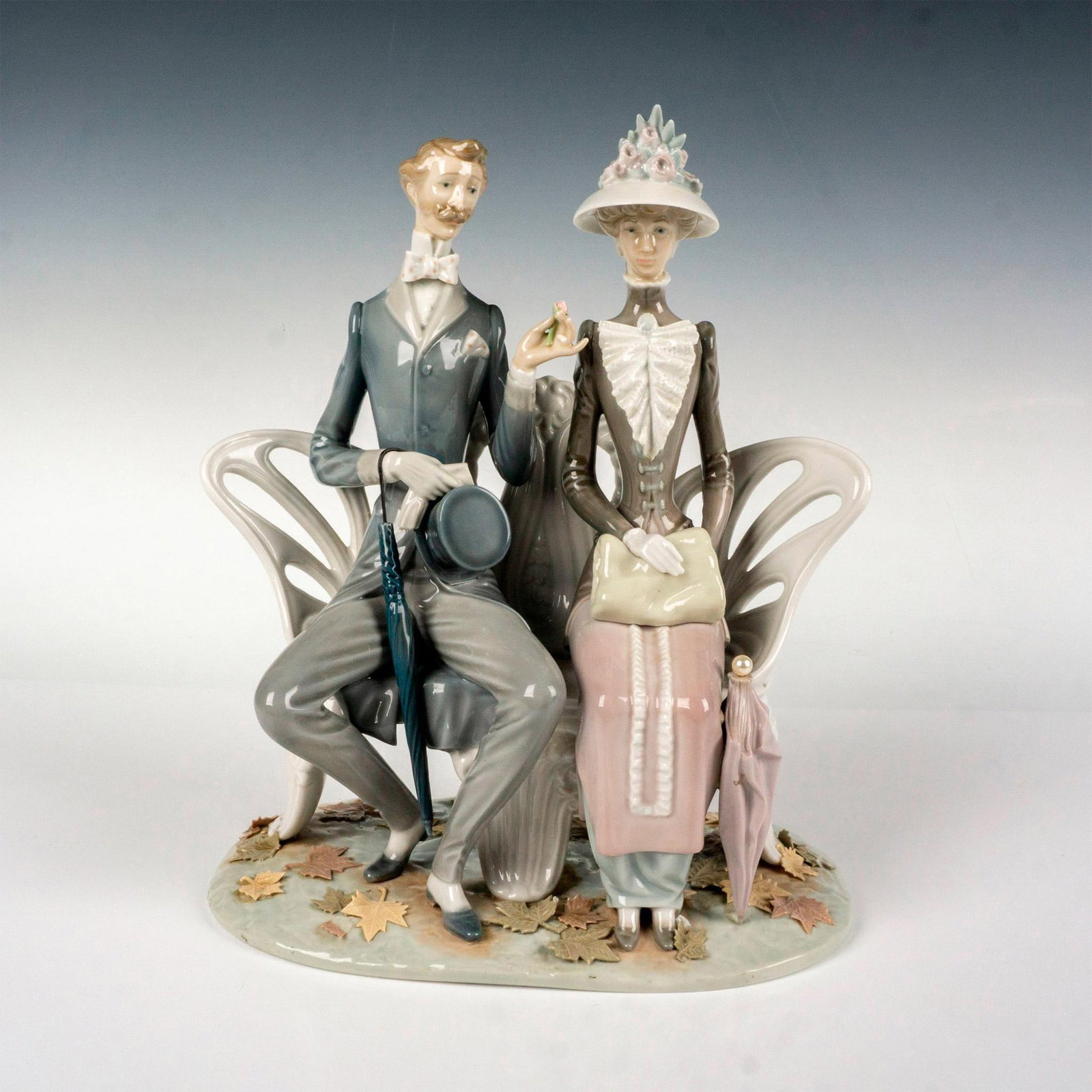 Lovers In The Park 1001274 - Lladro Porcelain Figurine: Glossy finish; Lladro backstamp. Artist: Antonio Ballester Issued: 1974 - 1993 Dimensions: 11.75"H Manufacturer: Lladro Country of Origin: Spain