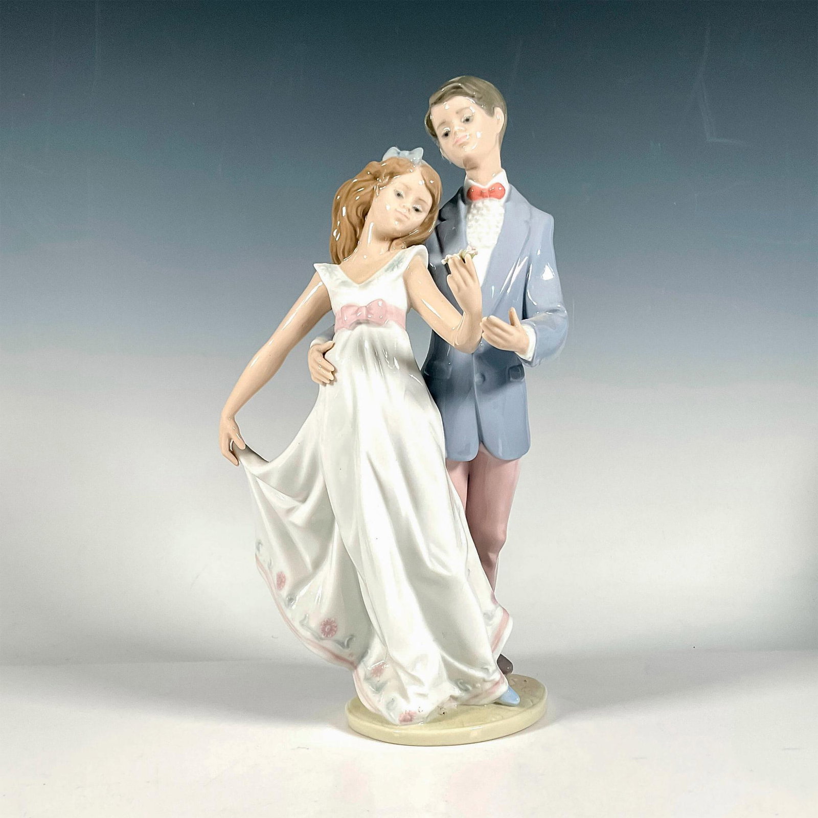 Now And Forever 1007642 - Lladro Porcelain Figurine: Glossy finish; Lladro backstamp. Includes original box. Box measures: 13.75"L x 9.25"W x 8"H. Artist: Francisco Polope Issued: 1995 - 1995 Dimensions: 10.75"H x 6"W Manufacturer: Lladro Country of Ori