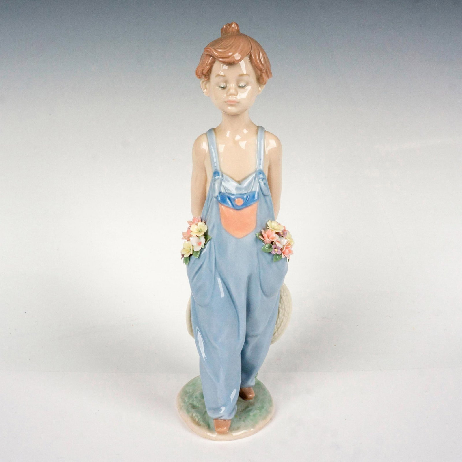 Pocket Full Of Wishes 1007650 - Lladro Porcelain Figurine: Glossy finish; Lladro backstamp. Artist: Antonio Ramos Issued: 1997 - 1997 Dimensions: 10.25"H x 3.5"W Manufacturer: Lladro Country of Origin: Spain