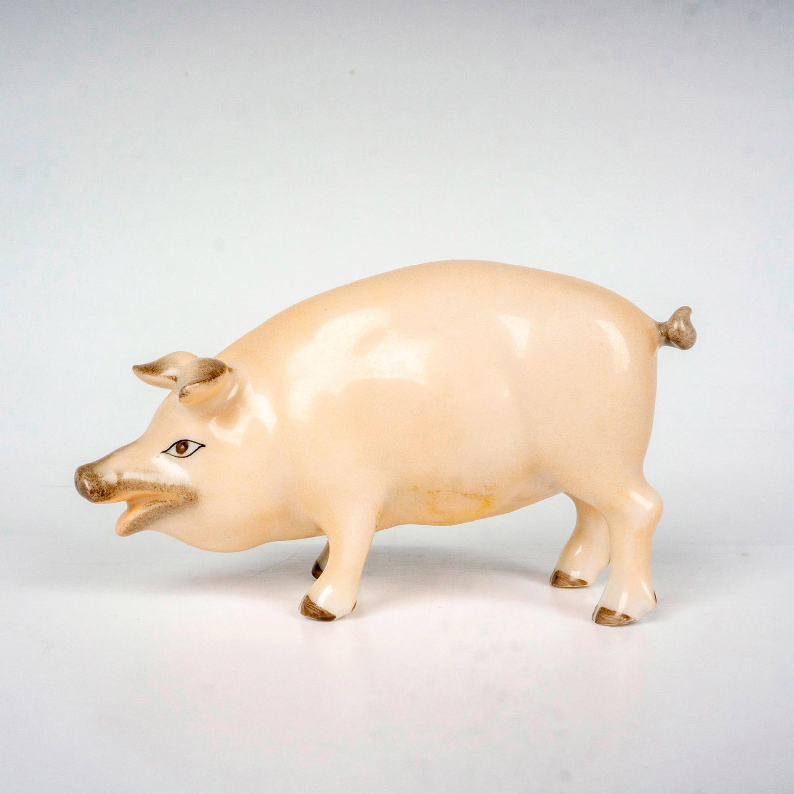 Herend Porcelain Figurine, Pig: Hand painted pig figure in a naturalistic coloration. Herend backstamp. Dimensions: 3"L x 1.5"W x 2"H Manufacturer: Herend Country of Origin: Hungary