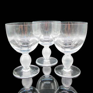 3pc Lalique Crystal Water Goblets, Langeais: Clear body with vertical frosted ribbed stem. Lalique etched mark. Artist: Marc Lalique Dimensions: 4"L x 4"W x 6"H Manufacturer: Lalique Country of Origin: France Provenance: Marie-Claude Laliqu