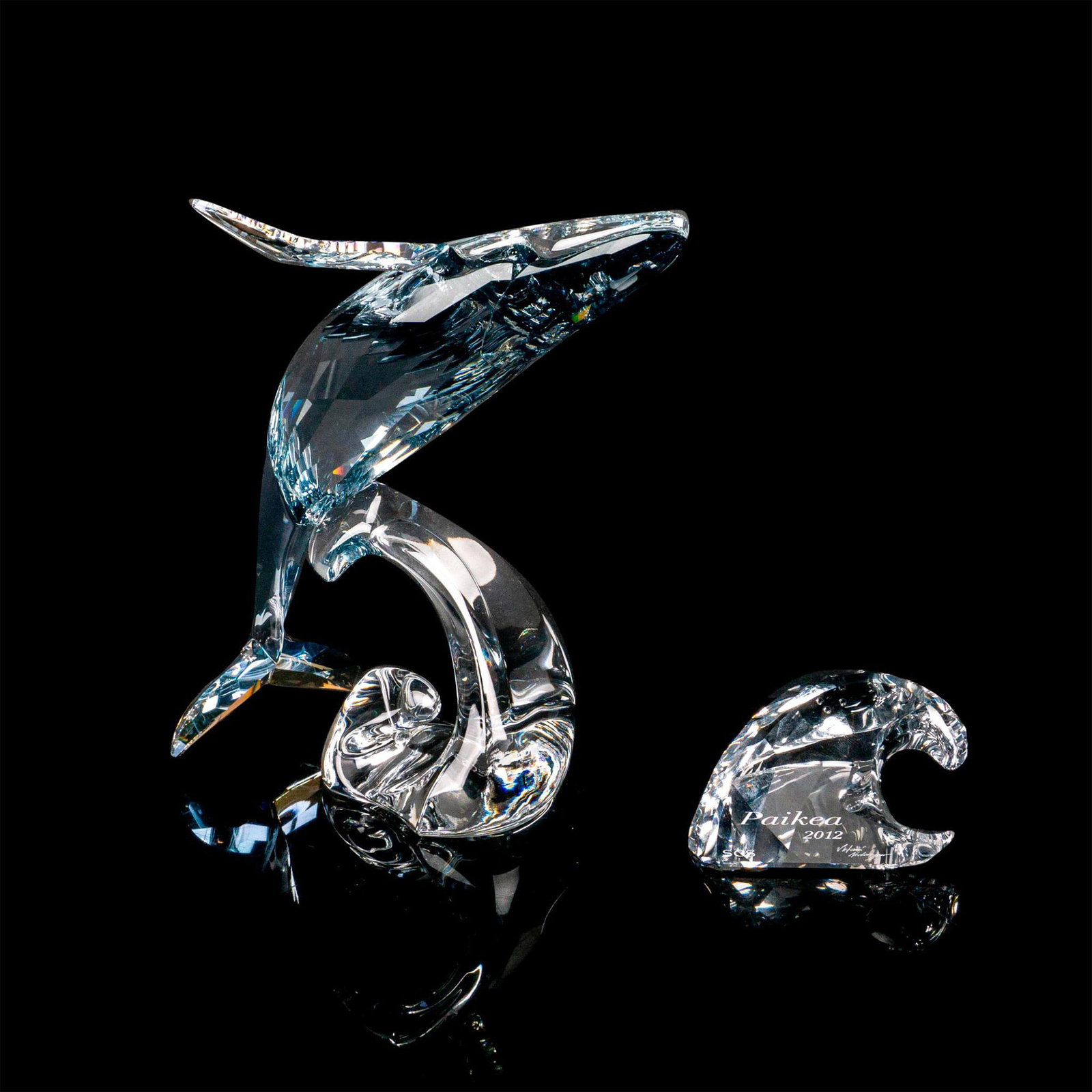 Swarovski Crystal Figurine + Plaque, Paikea: Beautiful lead crystal piece produced exclusively for SCS, with title plaque. Swarovski etched backstamp. Figurine measures: 5.5"W x 6.5"H. Plaque measures: 2.75"W x 1.75"H. This item has its original