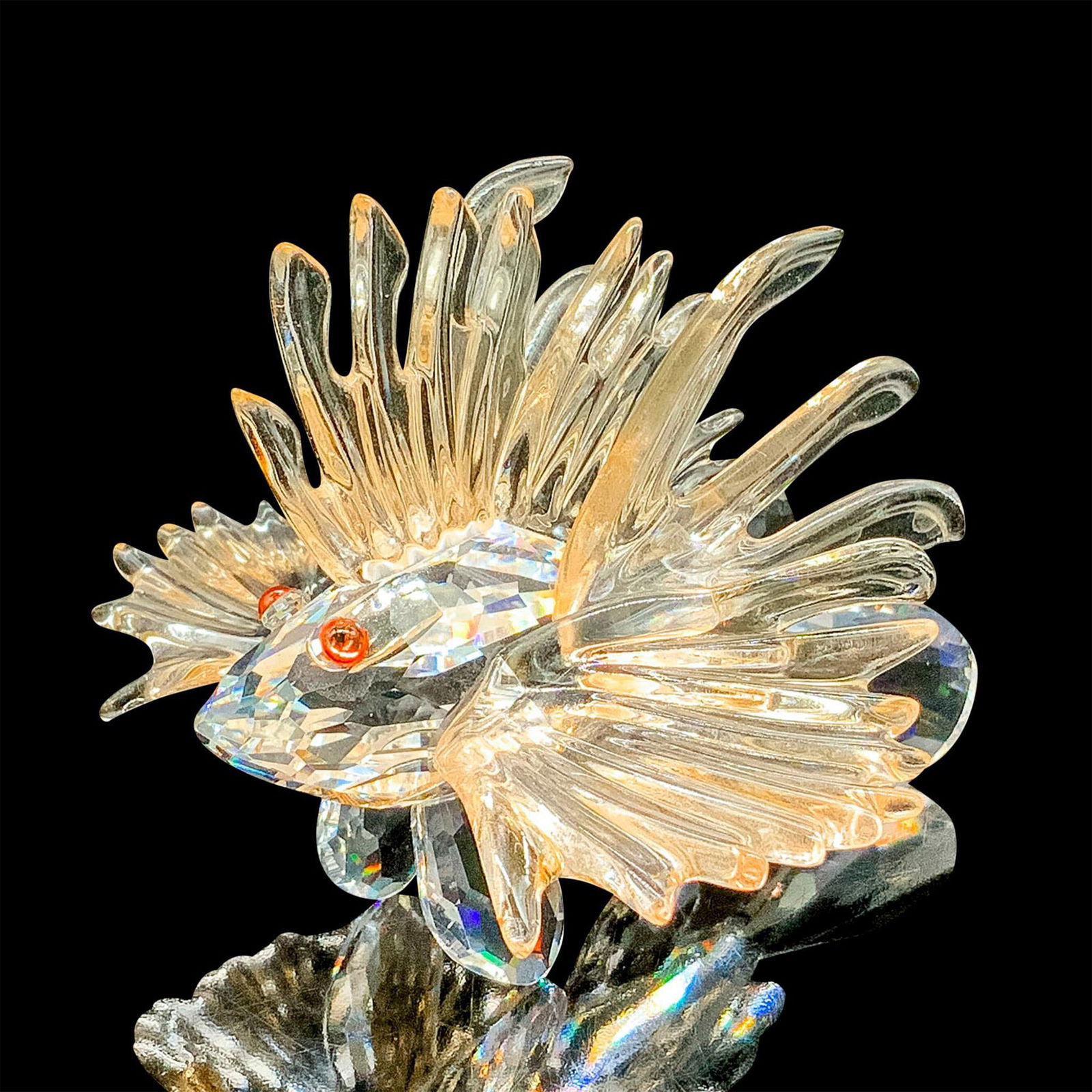 Swarovski Crystal Figurine, Lion Fish: This retired Swarovski crystal lion fish was part of the South Sea theme. The piece is made from clear crystal and has very light salmon fins. Item comes with original box measuring 5"dia. x 4"H. Arti