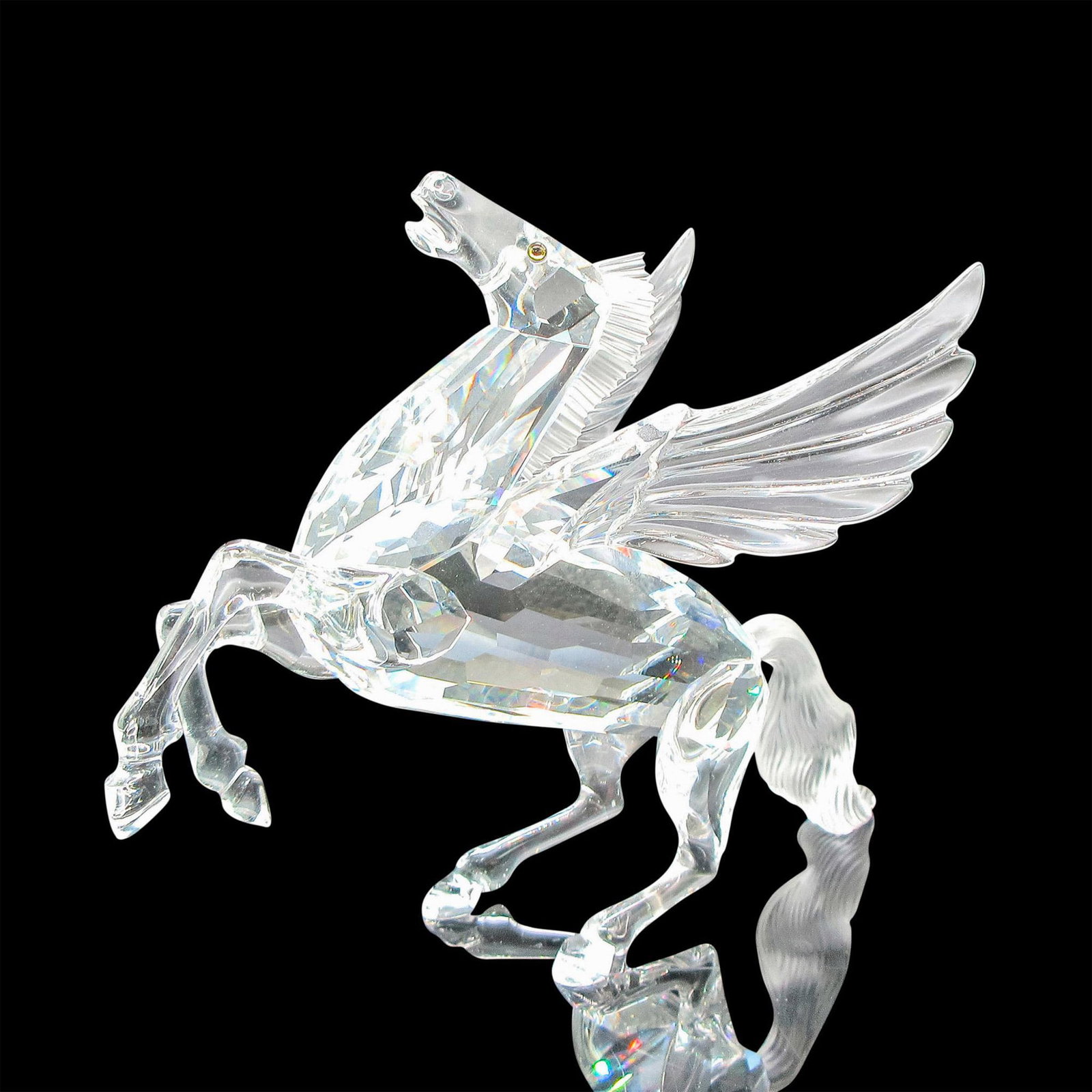 Swarovski Silver Crystal Figurine, The Pegasus: Clear faceted crystal body rearing up for flight has frosted tail and mane and amber eyes. Swarovski backstamp. This item has its original box: 9.25"L x 10"W x 5.25"H. Artist: Adi Stocker Issued: c. 1