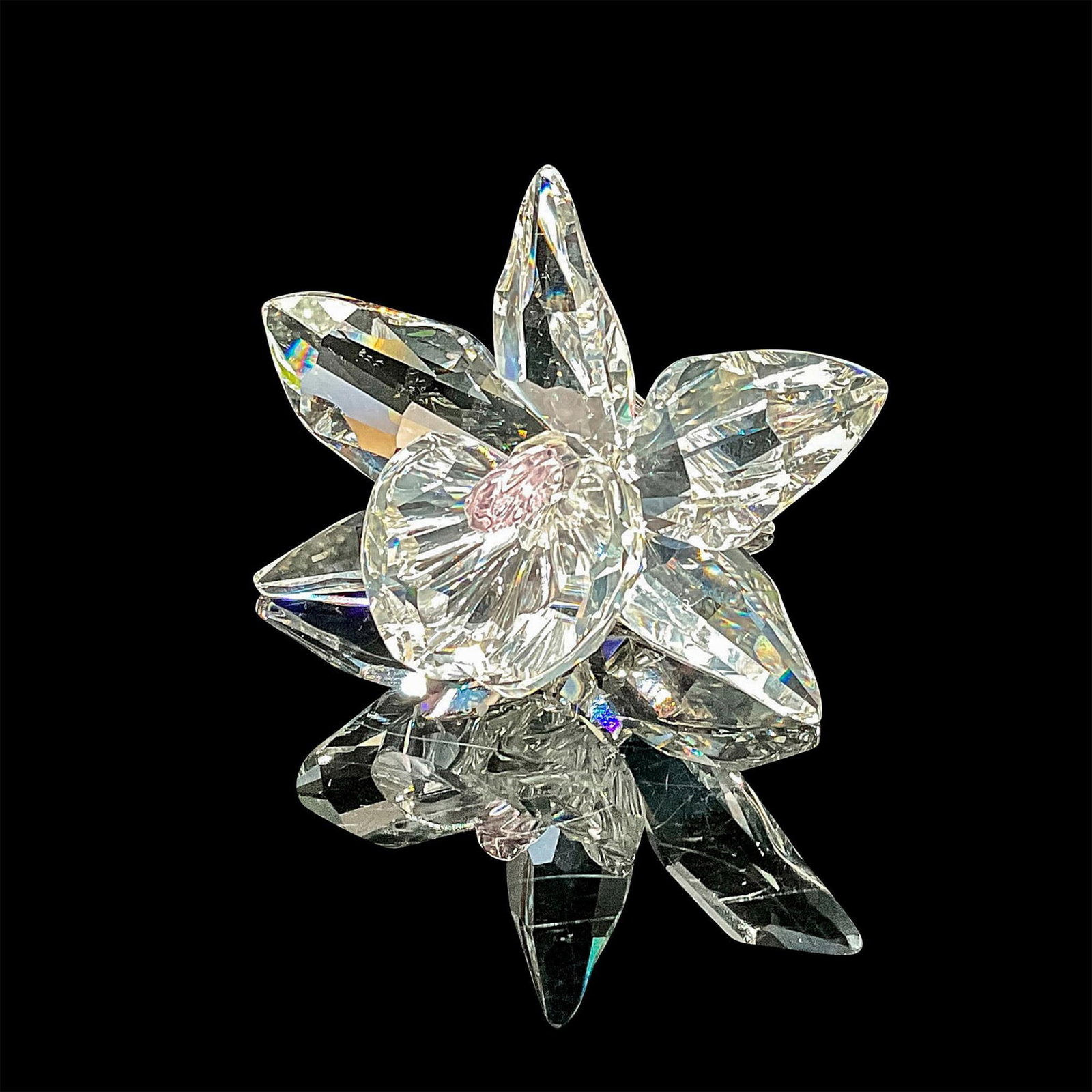 Swarovski Crystal Figurine, Orchid Light Pink Center: This dazzling pink orchid was part of the "Exquisite Accents" theme group. Introduced in 1998, this clear crystal piece with the gentle hue of the center complements the clear crystal petals that are 