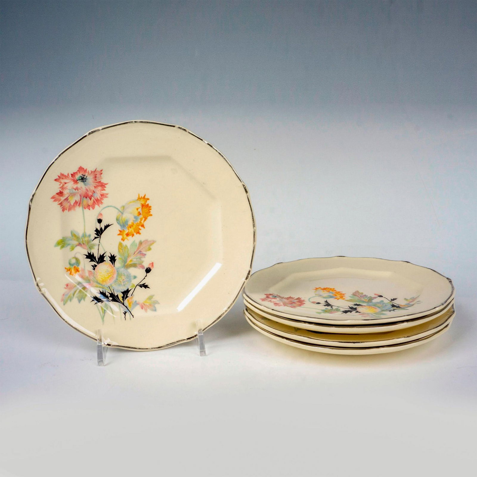 5pc Taylor, Smith & Taylor Co. Floral Dessert Plates: Cream-colored plates with metallic-silver trims adorned in a flower pattern. Taylor, Smith & Taylor Co. backstamp. Issued: 20th century Dimensions: 0.5"H x 6"dia Manufacturer: Taylor, Smith & Taylor C