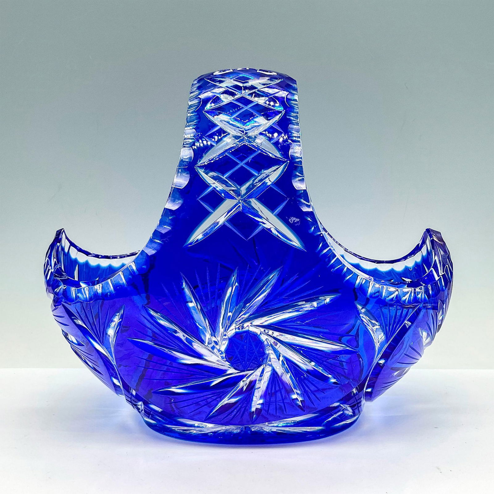 2pc Polish Blue Glass Decorative Baskets: Impressive, unique cobalt cut to clear cut vessels with starburst patterns and other intricate motifs. Largest measures: 9.5"L x 6"W x 8.5"H. Smallest measures: 6"L x 3.5"W x 6.5"H. Issued: 20th c. Co