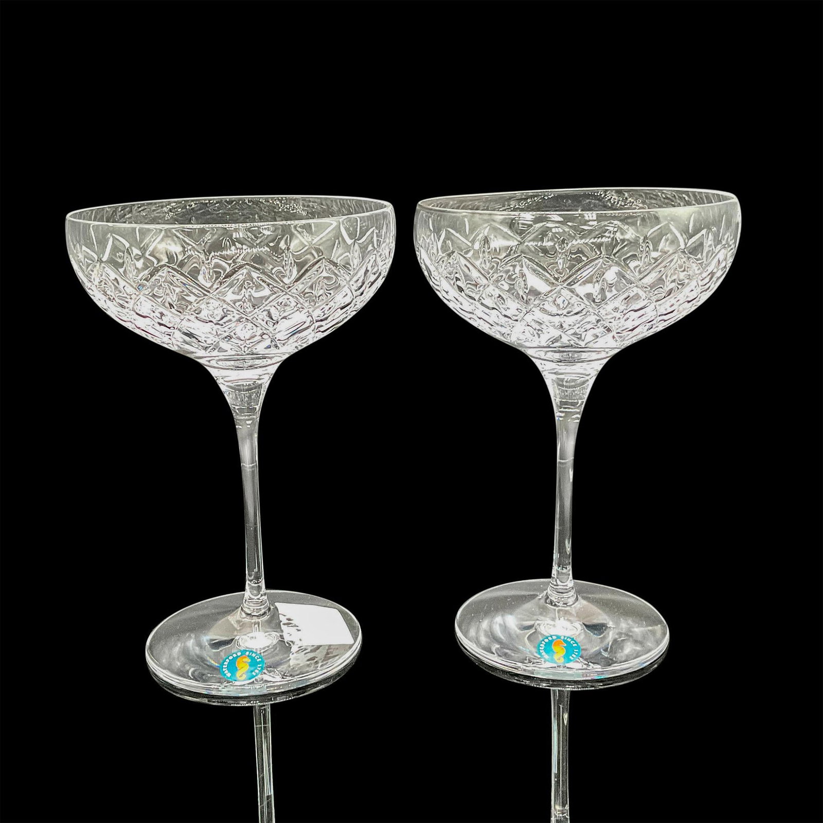 Waterford Crystal Cocktail Glasses, Astor: Includes set of 2 crystal glasses with cross hatch and teardrop design. Waterford acid mark and stickers. 1065208. This item has its original box: 11"L x 5.5"W x 9.5"H. Dimensions: 7"H x 5"dia. Manufa