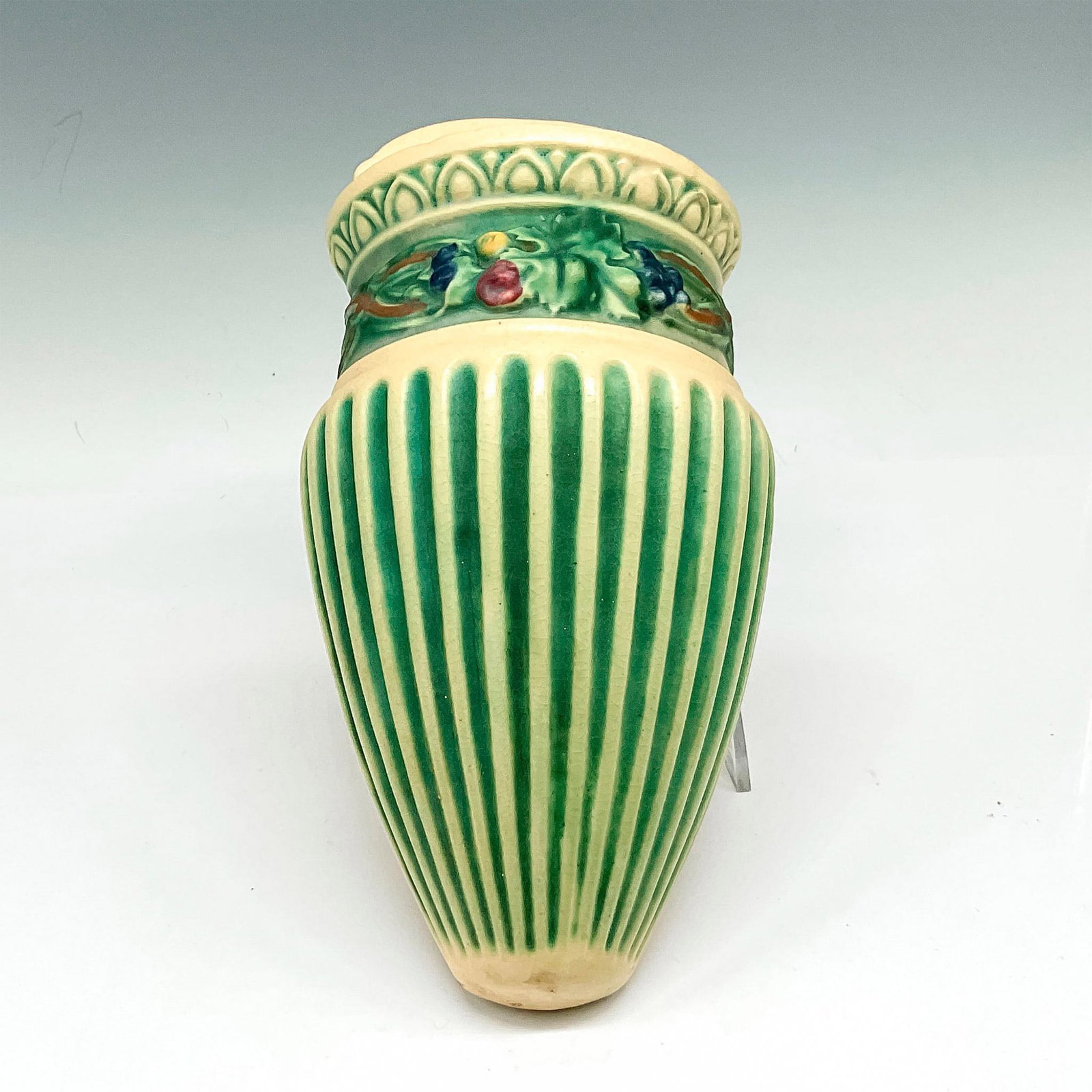 Roseville Pottery Wall Pocket, Corinthian: Cone shaped pocket with raised rib design and banding of florals and vines, Matte finish over light green and eggshell. Issued: 20th century Dimensions: 5"L x 2.5"W x 9.5"H Manufacturer: Roseville Cou