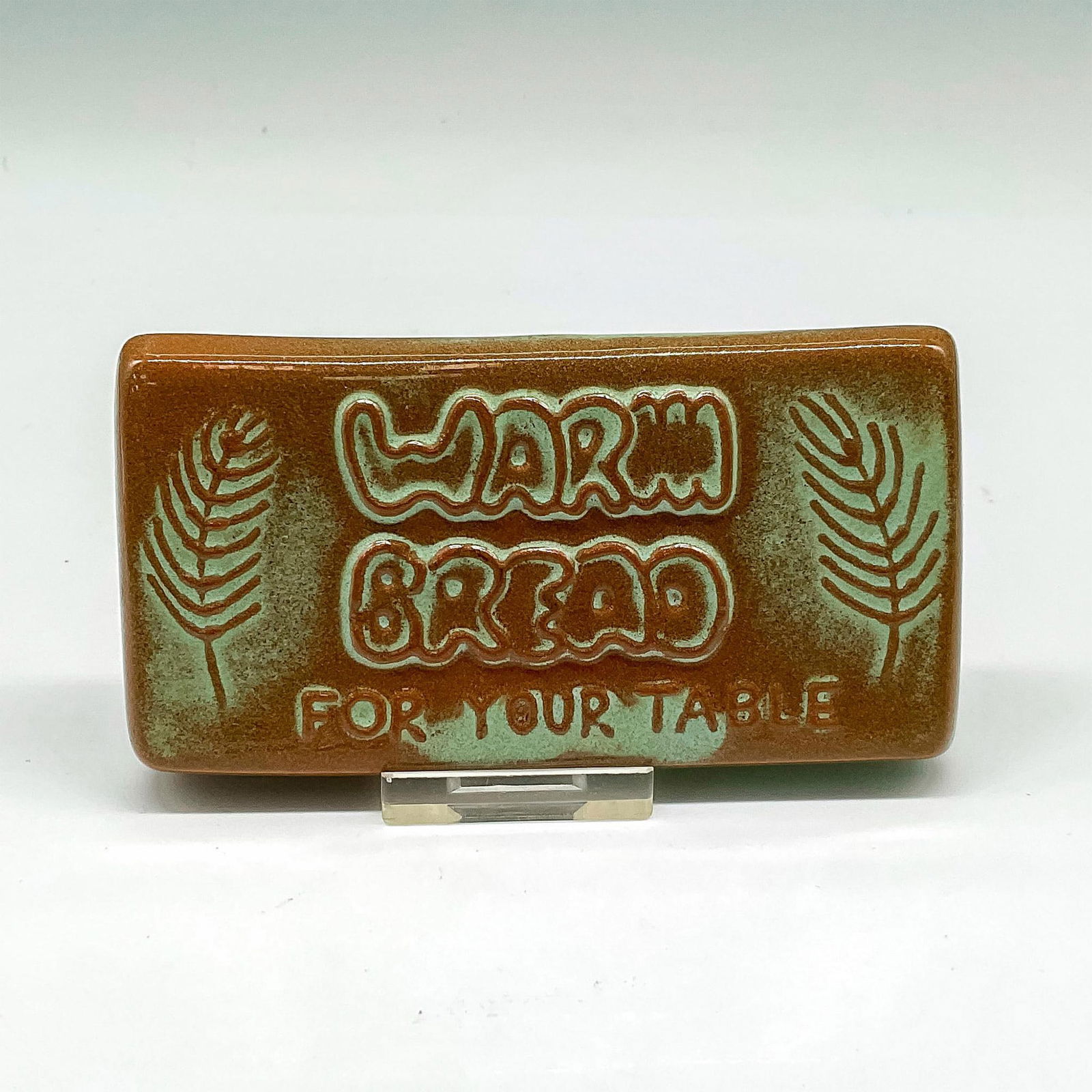 Vintage Frankoma Pottery Bread Warmer Tile: Brown and patina green tile with branches on side and instructions on reverse side for keeping breads warm. Frankoma raised mark. Issued: 20th century Dimensions: 4.5"L x 2.5"W x 0.75"H Manufacturer: