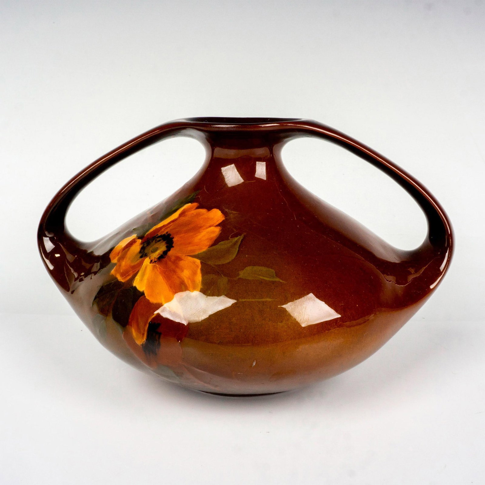Antique J B Owens Pottery Vase, Utopian: Mesmerizing double handled vase in a brown ground with a single flower. Founded in 1885, producing the wonderful Utopian pattern around 1896. J. B. Owens impressed backstamp. Issued: c. 1896 Dimension