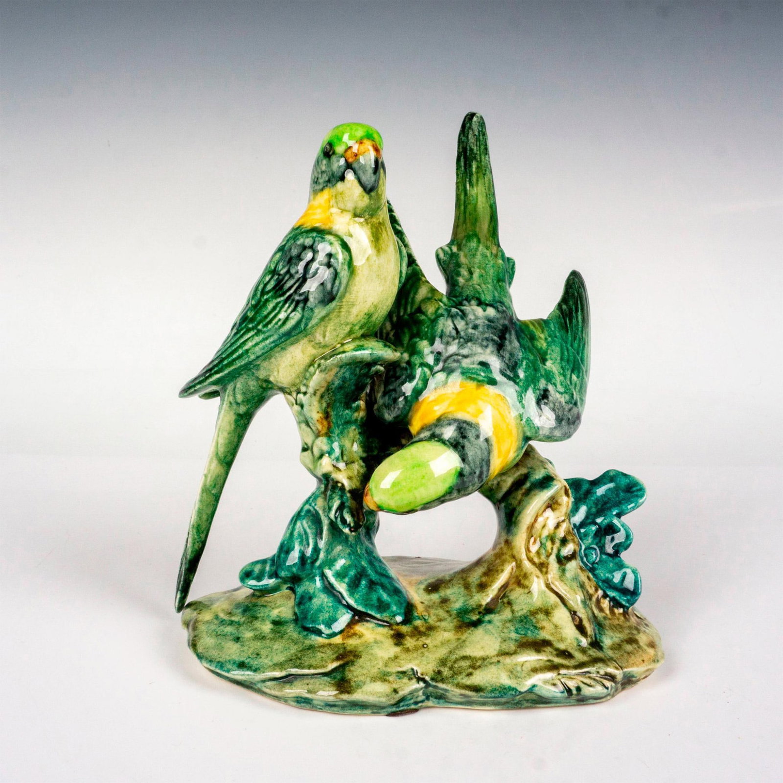 Stangl Pottery Birds Figurine, Double Parakeet: Hand colored art pottery figure depicting green colored parakeets sitting on branches. Painted in vivid colors. Stangl backstamp. Dimensions: 6.5"L x 5.5"W x 7.25"H Manufacturer: Stangl Pottery Countr