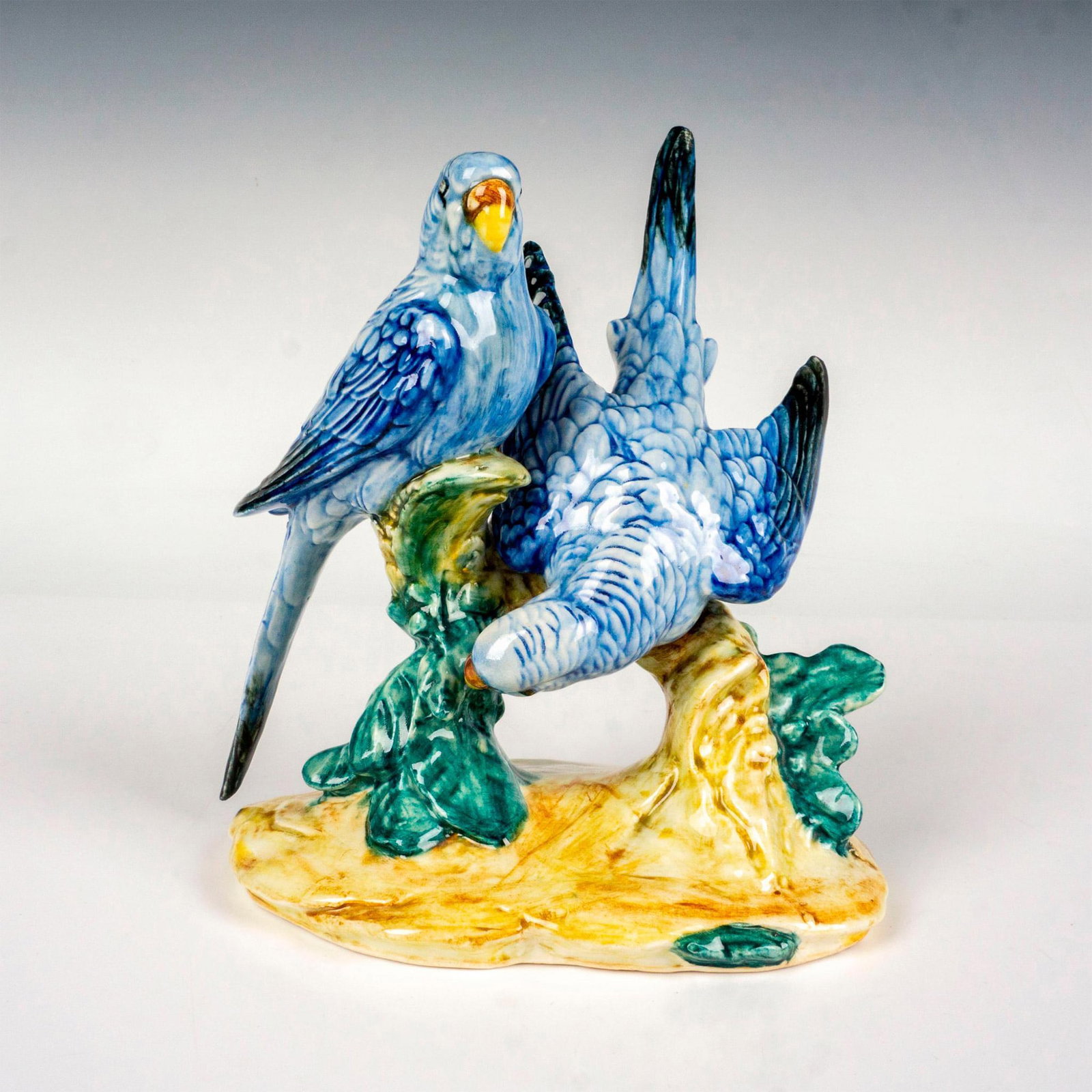 Stangl Pottery Birds Figurine, Double Parakeets: Hand colored art pottery figure depicting two blue parakeets resting on branches. Painted in vivid coloration. Stangl impressed backstamp. Dimensions: 6.25"L x 5"W x 7.25"H Manufacturer: Stangl Potter
