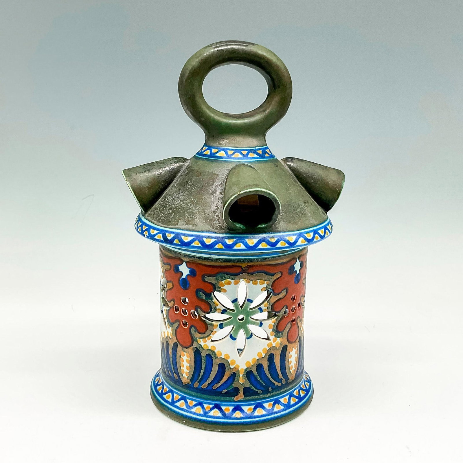 Gouda Porcelain Lantern, Camelia: Beautifully decorated light holder has a base color in muted green, with cutouts accentuated by colorful design in rust, blue and green. Gouda backstamp. 1041. Manufacturer: Gouda Country of Origin: H