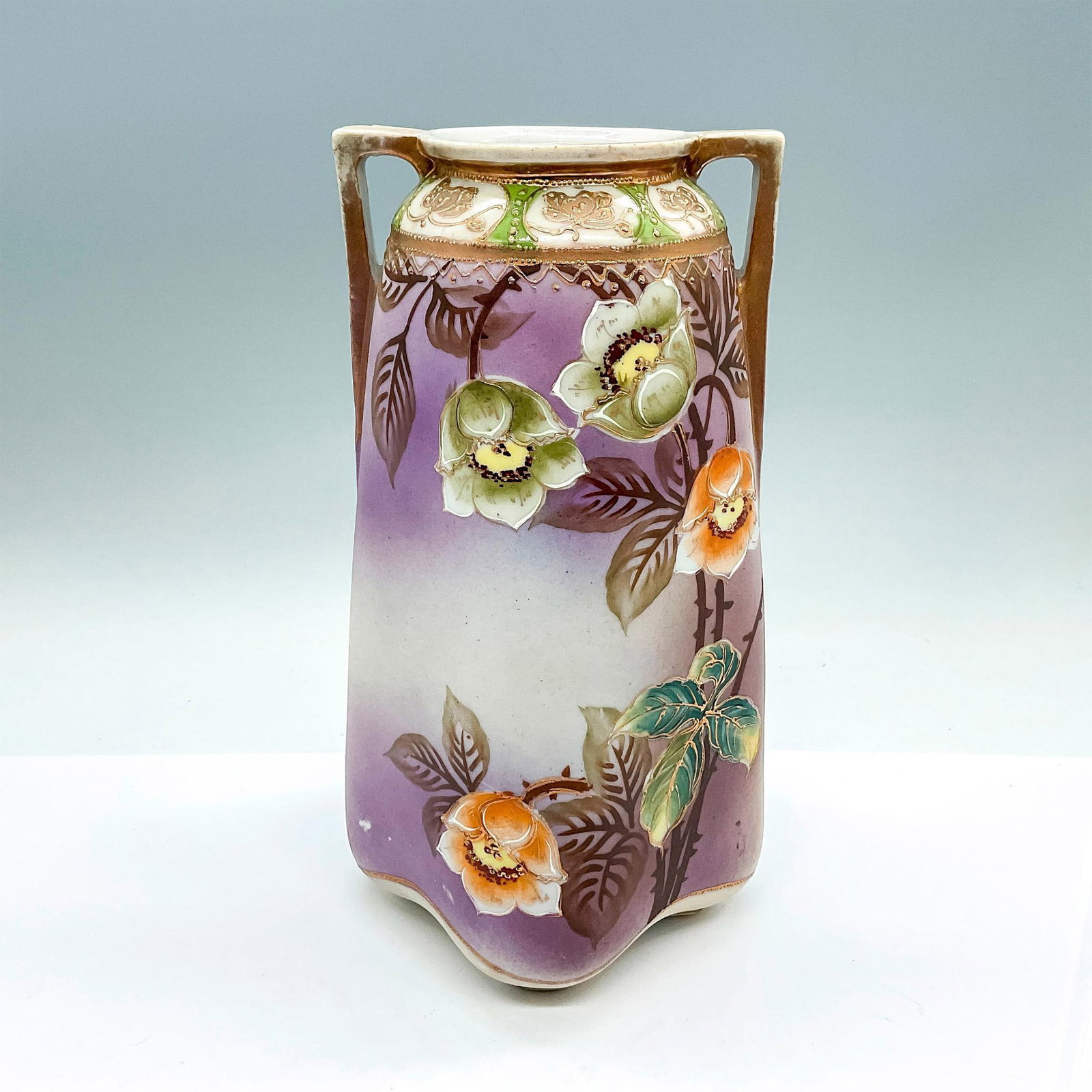 Te-Oh Nippon China Gilded Floral Vase: A beautiful hand painted vase with double handles. Adorned with white and orange hawthorn flowers, and gilded accents. Te-Oh Nippon backstamp. Dimensions: 5.25"L x 5.25"W x 9.5"H Manufacturer: Te-Oh N