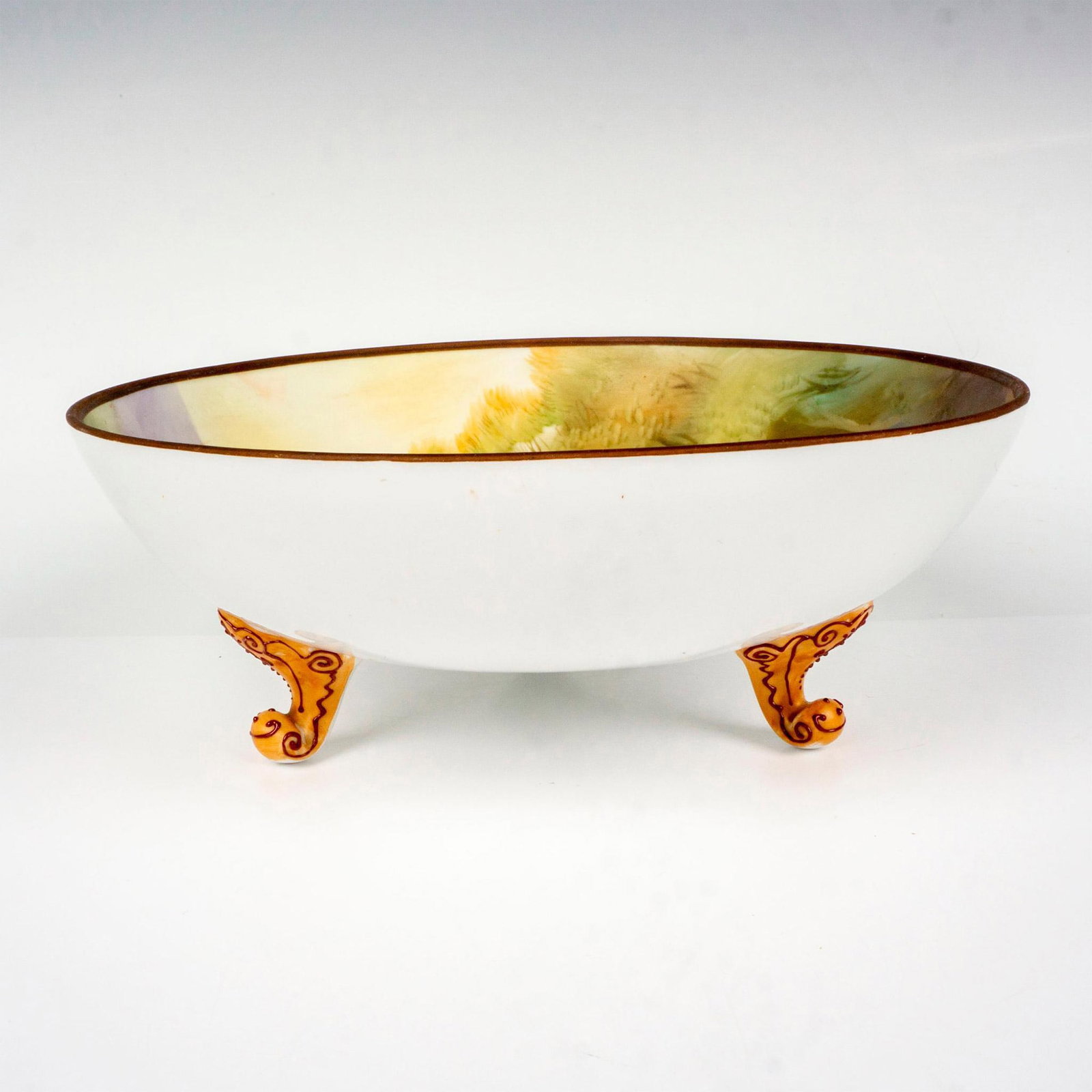 Nippon Porcelain Squirrel Nut Bowl: All original, three-foot bowl which is decorated with a raised relief depicting a squirrel with two peanuts by its little foot. Nippon backstamp. Dimensions: 3.25"H x 9"dia. Manufacturer: Nippon Count