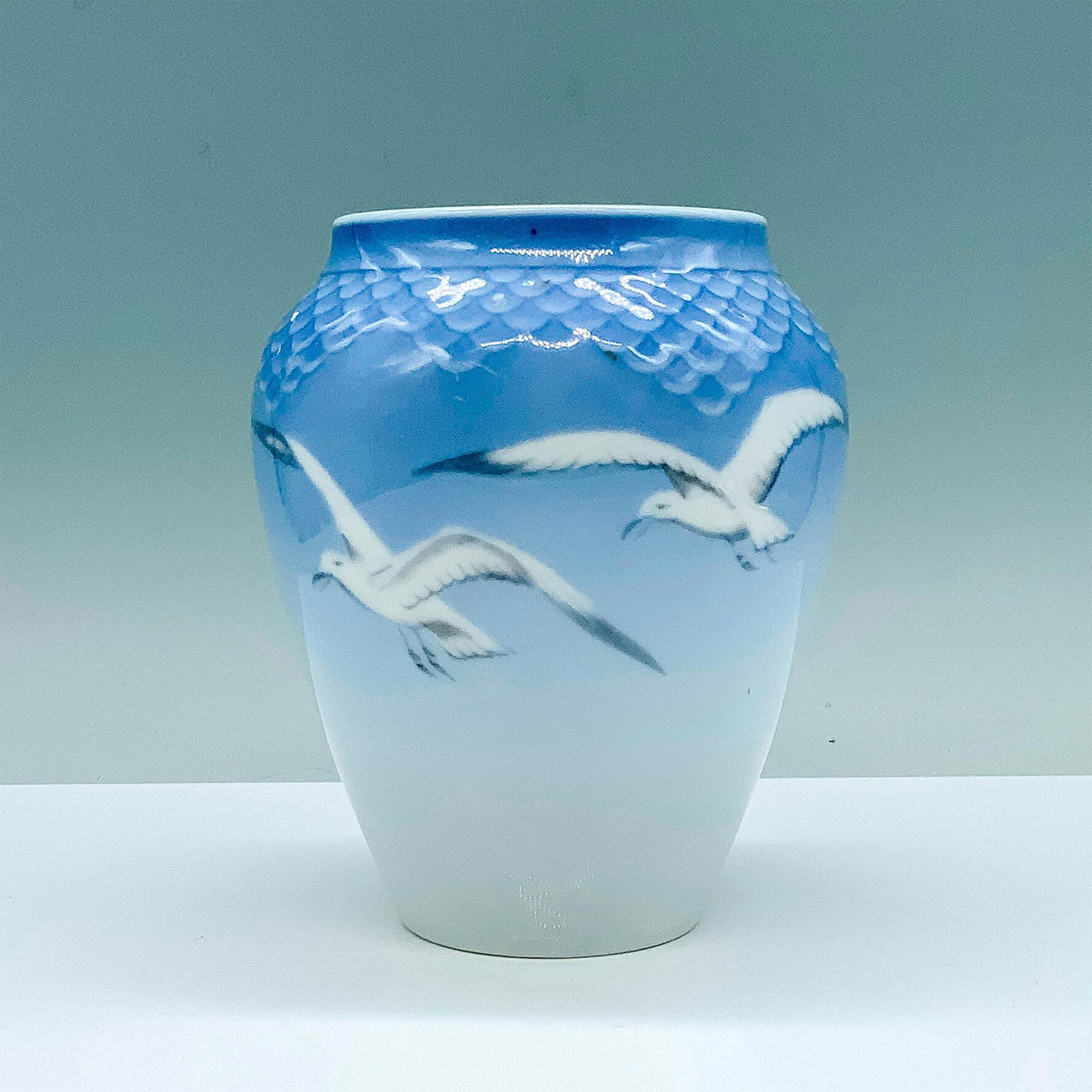 Bing & Grondahl Porcelain Seagull Vase: A small vase with blue and white coloration that has seagulls in flight painted on the center. B and G backstamp. Manufacturer: B and G Country of Origin: Denmark