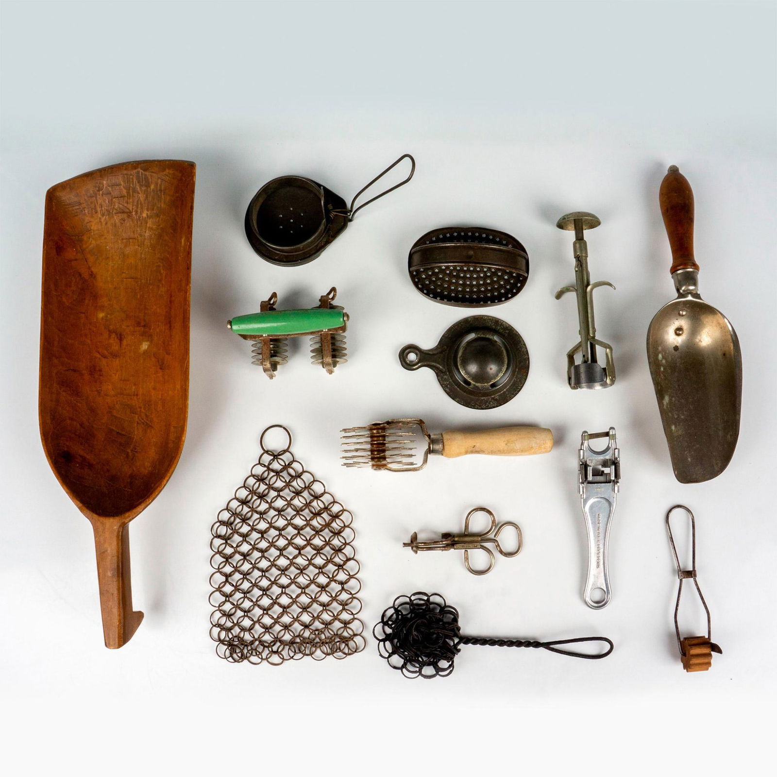 13pc Vintage Pastry & Baking Kitchen Utensils: This vintage kitchen utensil grouping includes a large hand-carved scoop, small metal scoop with wood handle, two egg separators, docker, tin cheese grater, 2 chain-mail cast iron pot scrubbers, pastr