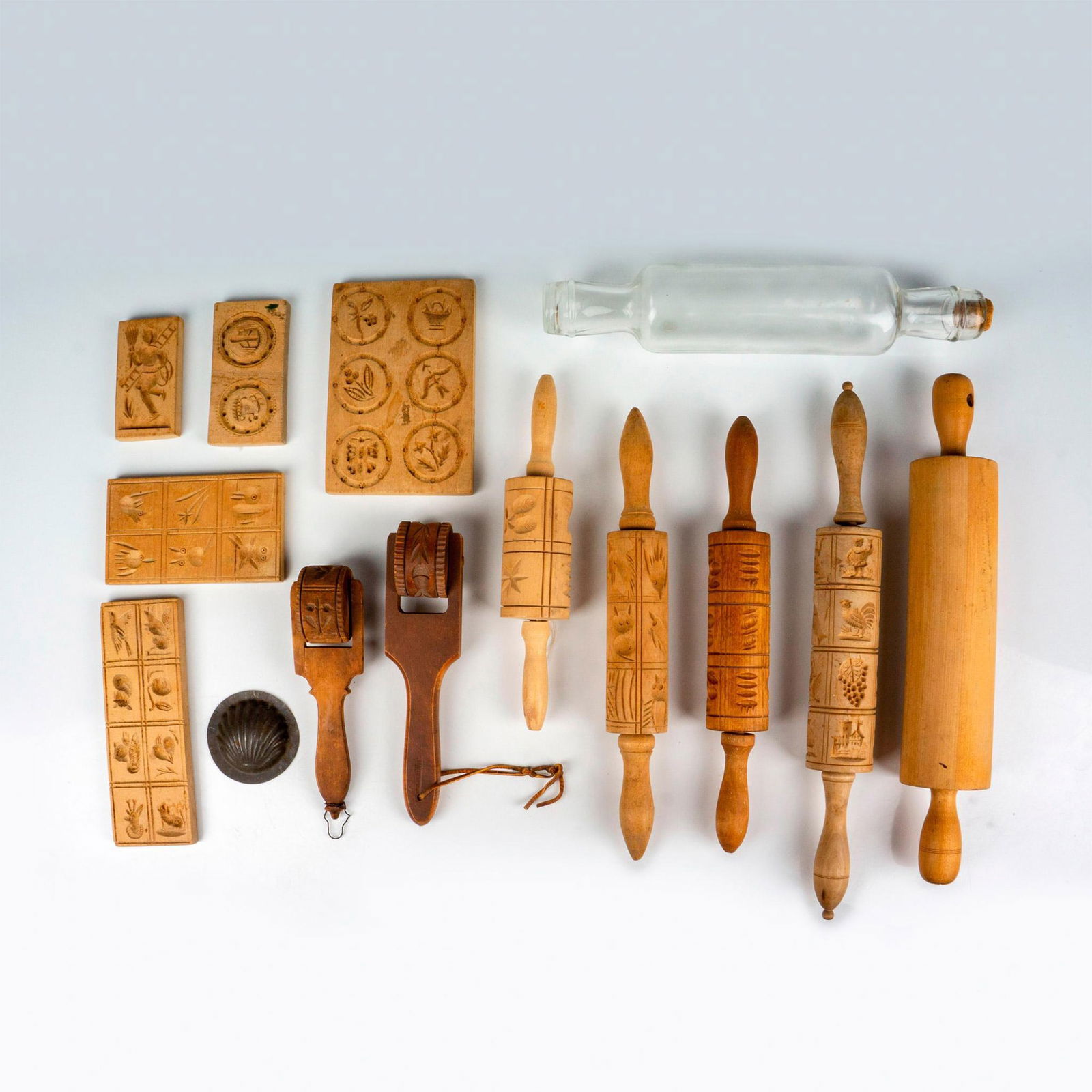 14pc Vintage Pastry/Cookie Rolling Pins and Cookie Molds: This vintage grouping includes 6 cookie press rolling pins, 5 cookie mold blocks, a glass rolling pin, one-piece rolling pin, and a tin madeleine mold. Issued: 20th Century