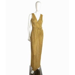 Vintage Gold Glitter Evening Dress: Sleek sleeveless gown with cross neck and ruffled edge. Braided rope belt and zippered back. Gown length 57". Issued: 20th century Country of Origin: United States