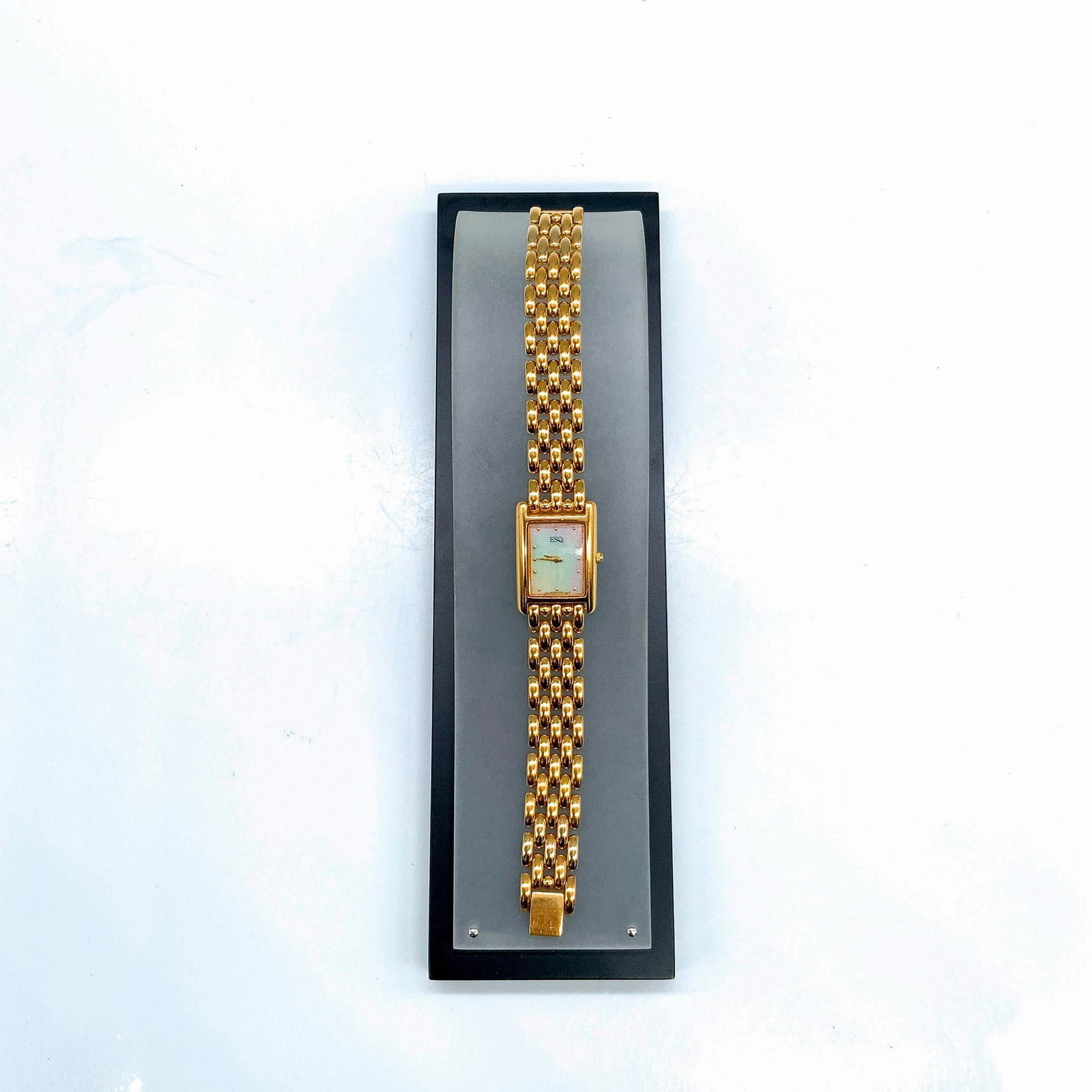 Esquire Gold Tone Mother of Pearl Face Swiss Quartz Watch: Beautiful Esquire watch with a rectangular mother of pearl face and stainless steel back. Gold metal hands and dotted number markers. Item comes with additional links, original instructions, warranty