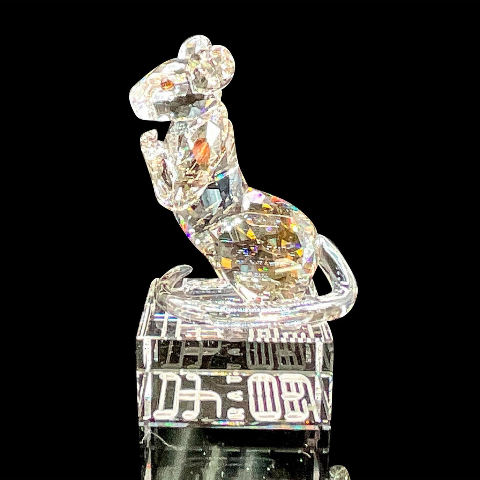Swarovski Crystal Figurine, Chinese Zodiac Rat: Brilliant clear crystal figure of an alert rat standing on its hind legs. Swarovski etched backstamp. Includes original box 5.75"L x 5.75"W x 3.75"H. The zodiac name is engraved in English and Chinese