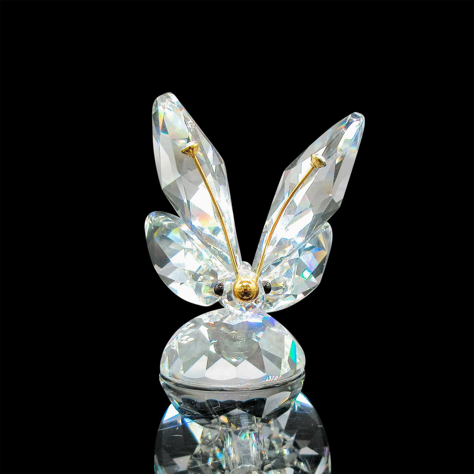 Swarovski Crystal Figurine, Butterfly with Gold Antennae: Part of the In a Summer Meadow Collection. Sparkling clear crystal butterfly with crystal tipped gold antennae. Swarovski backstamp. Issued: 1982 - 2006 Dimensions: 2"L x 1.75"W x 2"H Manufacturer: Sw