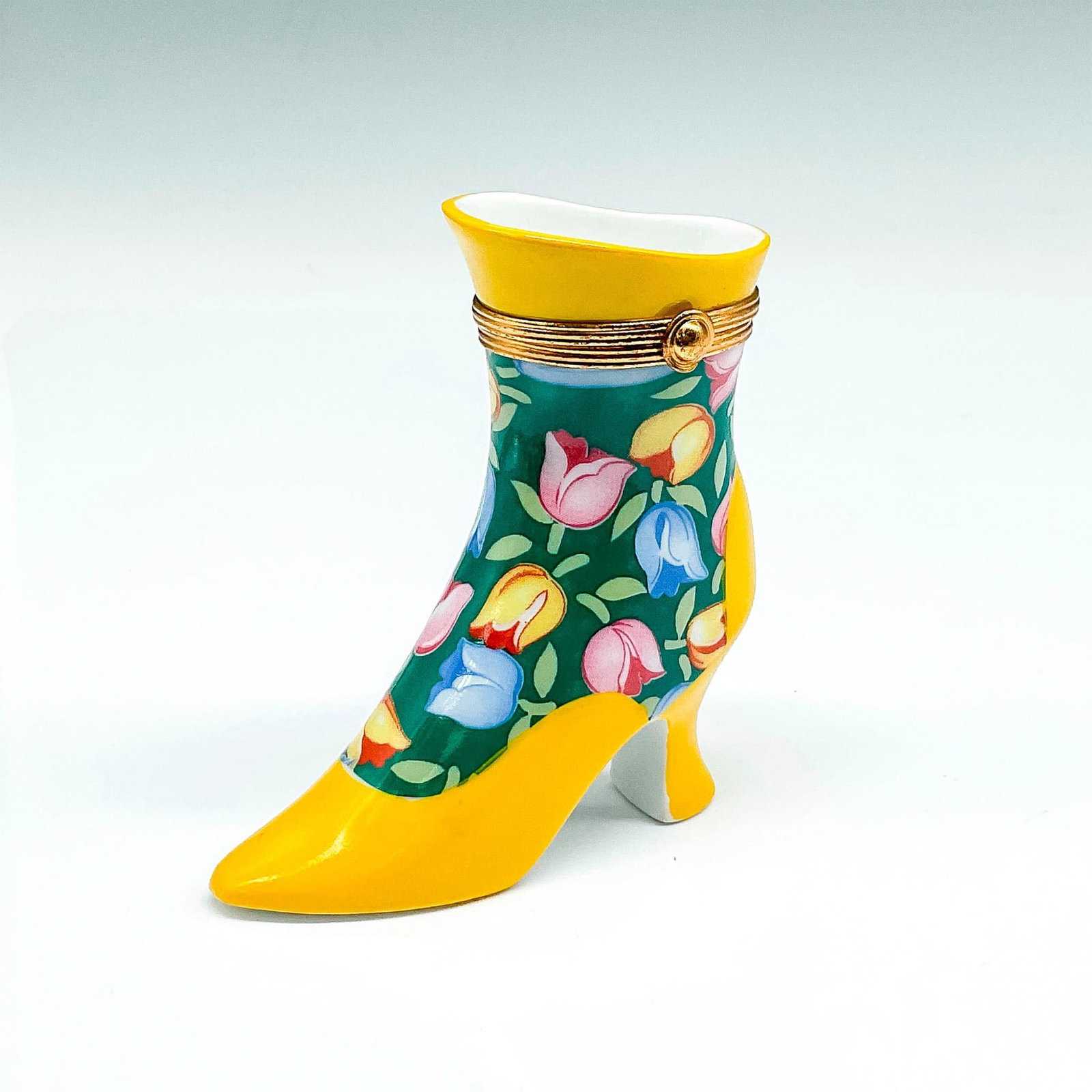 Limoges Fait Main Porcelain Boot Trinket Box: Bright yellow high heeled boot colored in yellow, blue and rose tulips on green background. Top of boot has hinged opening with clasp closure. Limoges Fait Main backstamp. Issued: 20th century Dimensi