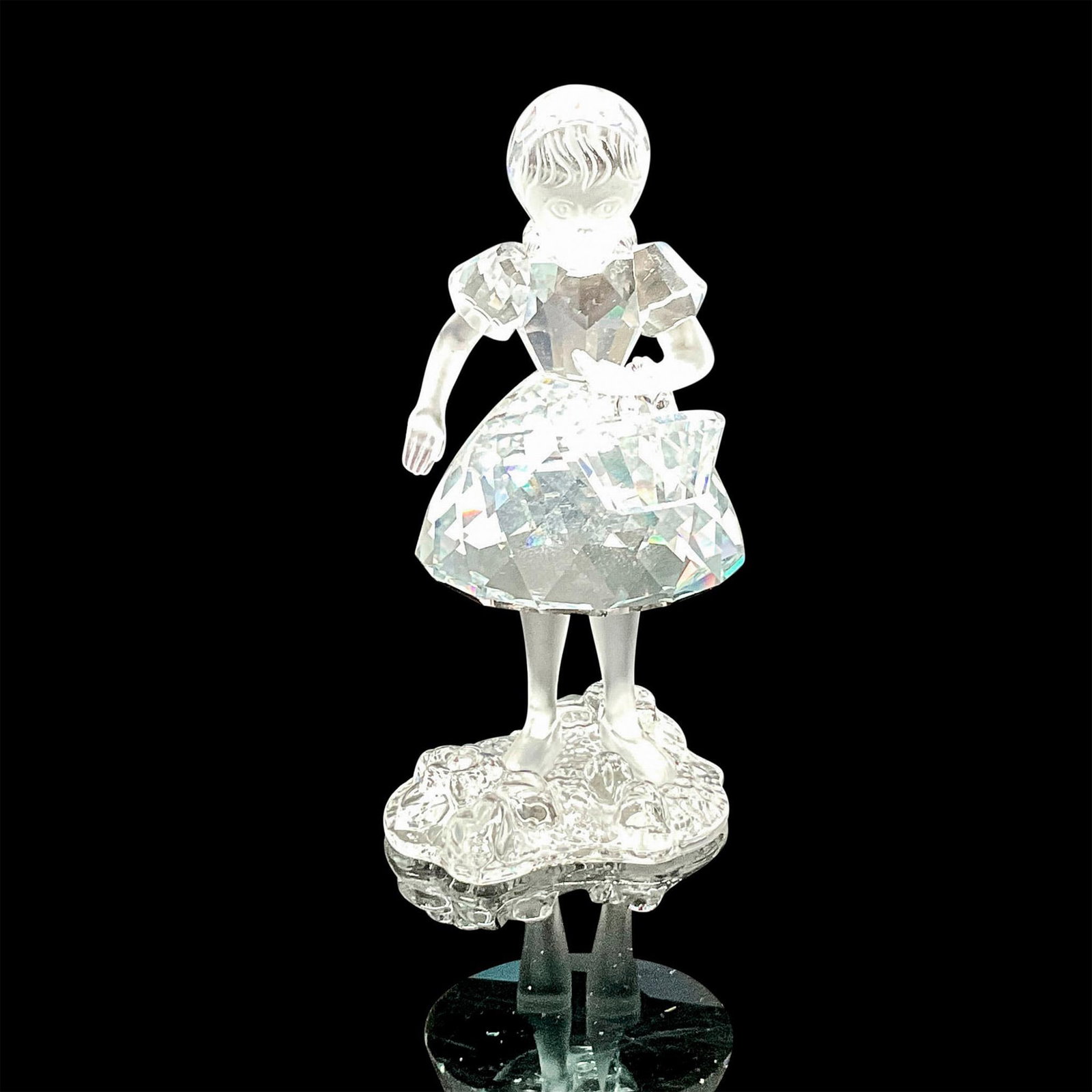 Swarovski Silver Crystal Figurine, Red Riding Hood: Clear crystal figure with satin crystal face and arms holding a removeable crystal basket. Swarovski backstamp. 7550 000 001. This item has its original box: 5"H x 6"dia. Issued: 20th century Dimensio
