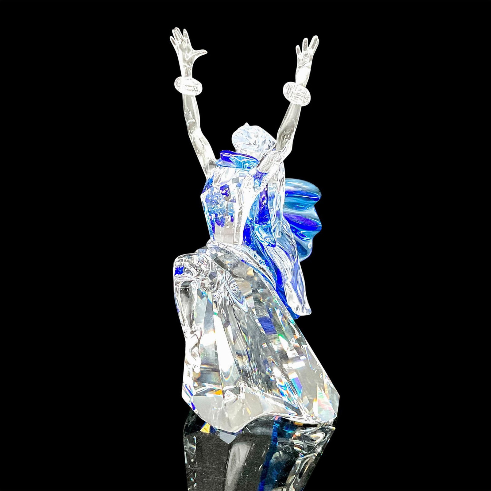 Swarovski Crystal Figurine, Magic of Dance, Isadora 2002: Stunning clear crystal figure, celebrating the art of dance. A blue crystal scarf around her neck flows to the back. Blue crystals are embedded along the back. Wrist are adorned with crystal bands. Sw