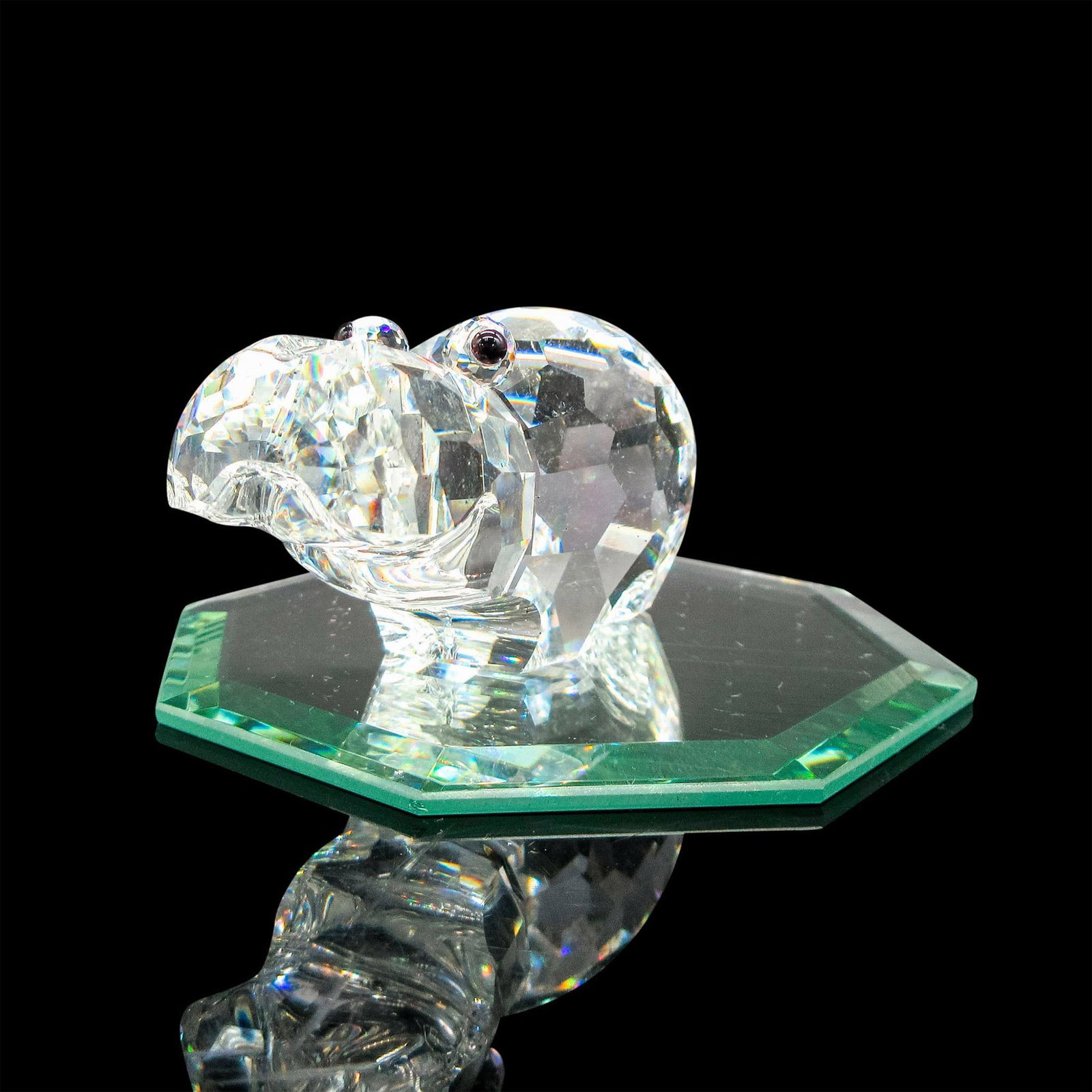 Swarovski Crystal Figurine, Hippopotamus: Part of the African Wildlife theme group. Clear faceted body with frosted tail and black crystal eyes. Swarovski backstamp. This item has a mirrored base included 3"L x 3"W. Artist: Adi Stocker Issued