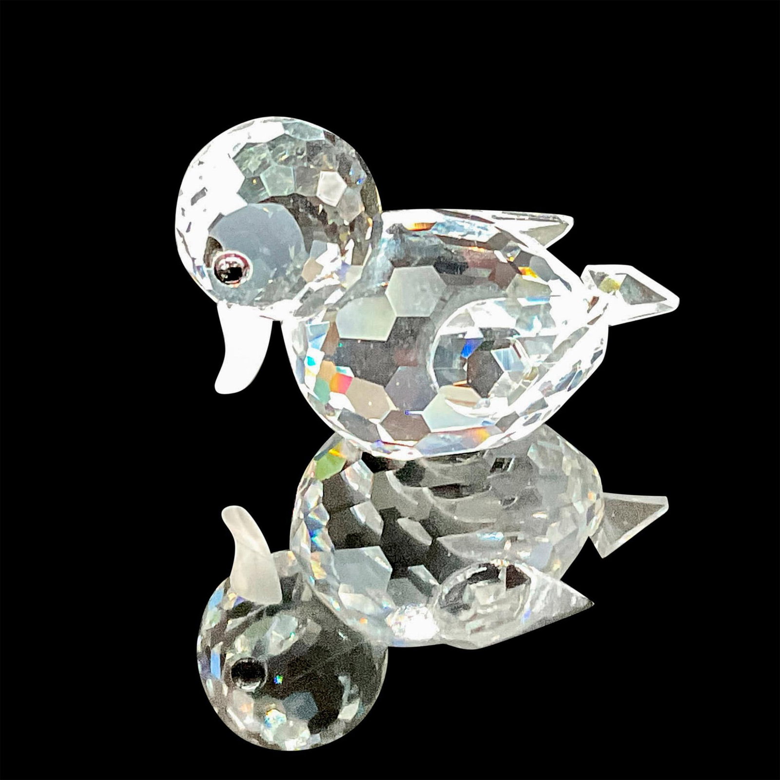 Swarovski Crystal Figurine, Duck Swimming Mini: This swimming ducky figurine features a clear faceted head and body, accentuated by expressive black eyes and a frosted bill. This item has its original box which measures 1.5"H x 3"dia. Swarovski etc