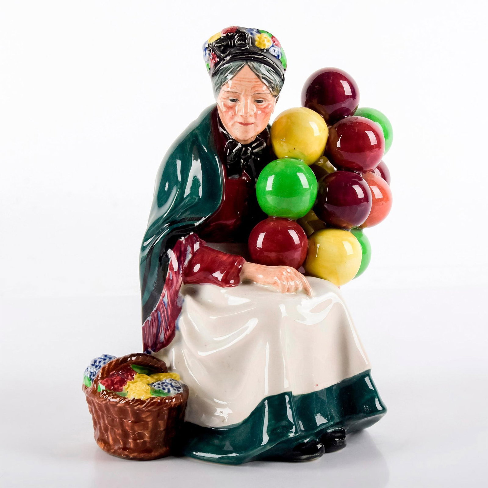 Old Balloon Seller HN1315 - Royal Doulton Figurine: Elderly woman selling a bunch of colorful balloons. Royal Doulton backstamp. Street Vendor series. Weight: 1 lb 6.6 oz #royaldoulton #figurine #oldballoonseller Artist: Leslie Harradine Issued: 1929 -