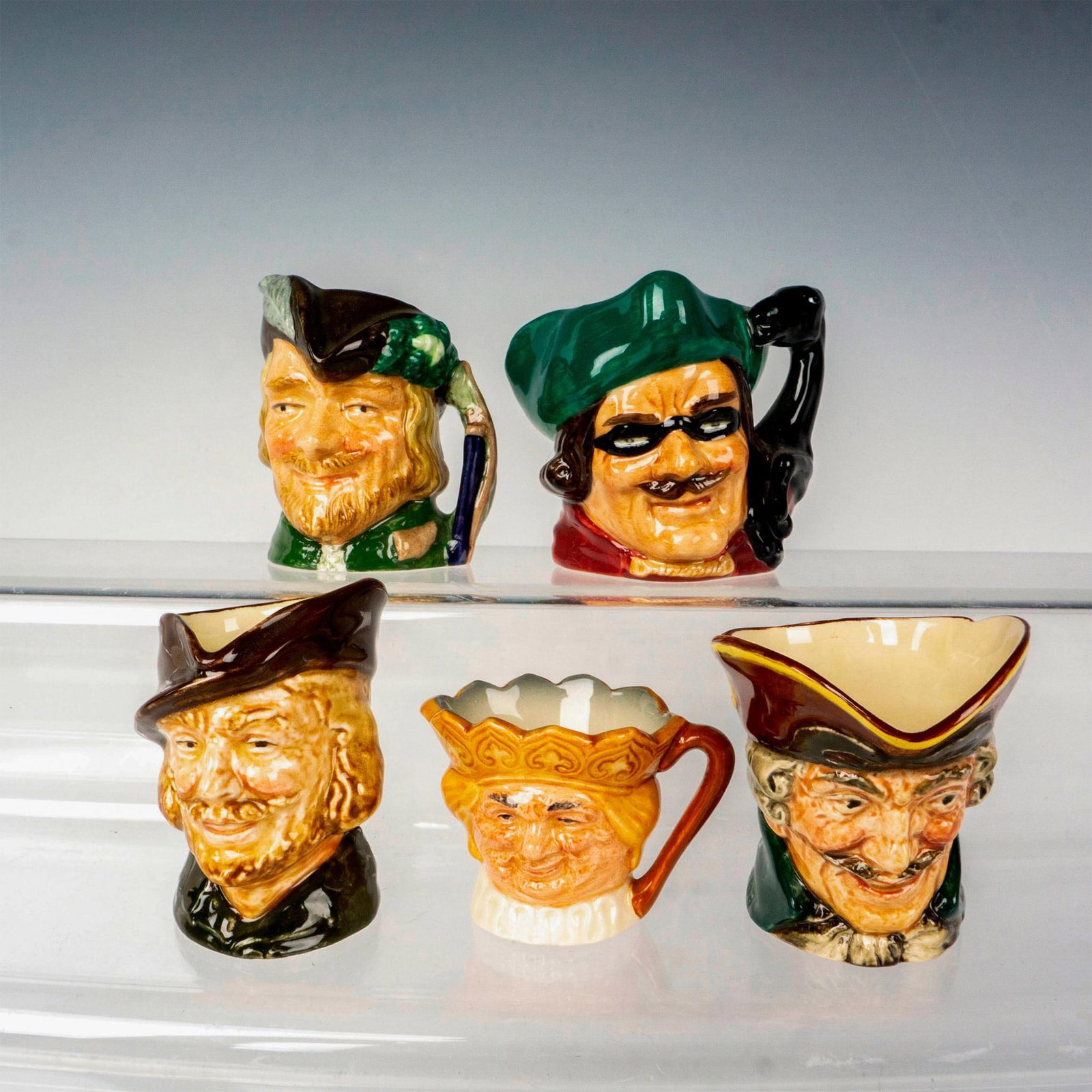 5pc Royal Doulton Mini/Tiny Literary Character Jugs: This literary collection of Royal Doulton Character jugs includes 2 Robin Hood, 2 Dick Turpin and a tiny Old King Cole D6871. The largest measures 2.5"H. Royal Doulton backstamp. Issued: 20th Century 