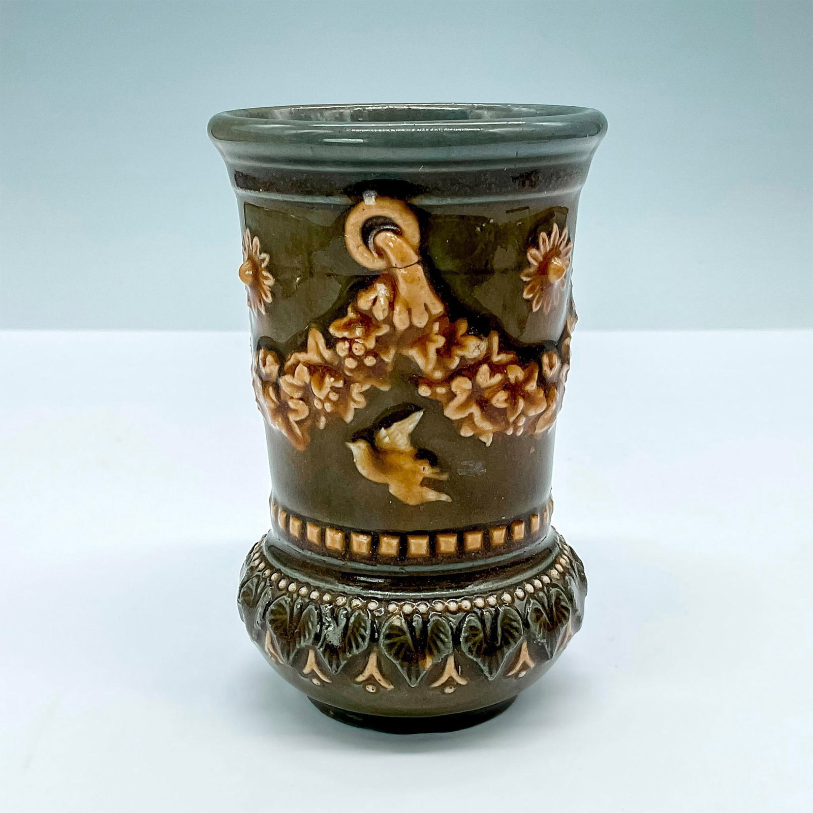 Doulton Lambeth Miniature Stoneware Vase: Lovely highly accented vase with white garlands and doves. Stamped Doulton Lambeth to base. Artist's initials stamped to base. Artist: Various Issued: 1881 Dimensions: 4"H Manufacturer: Doulton Lambet