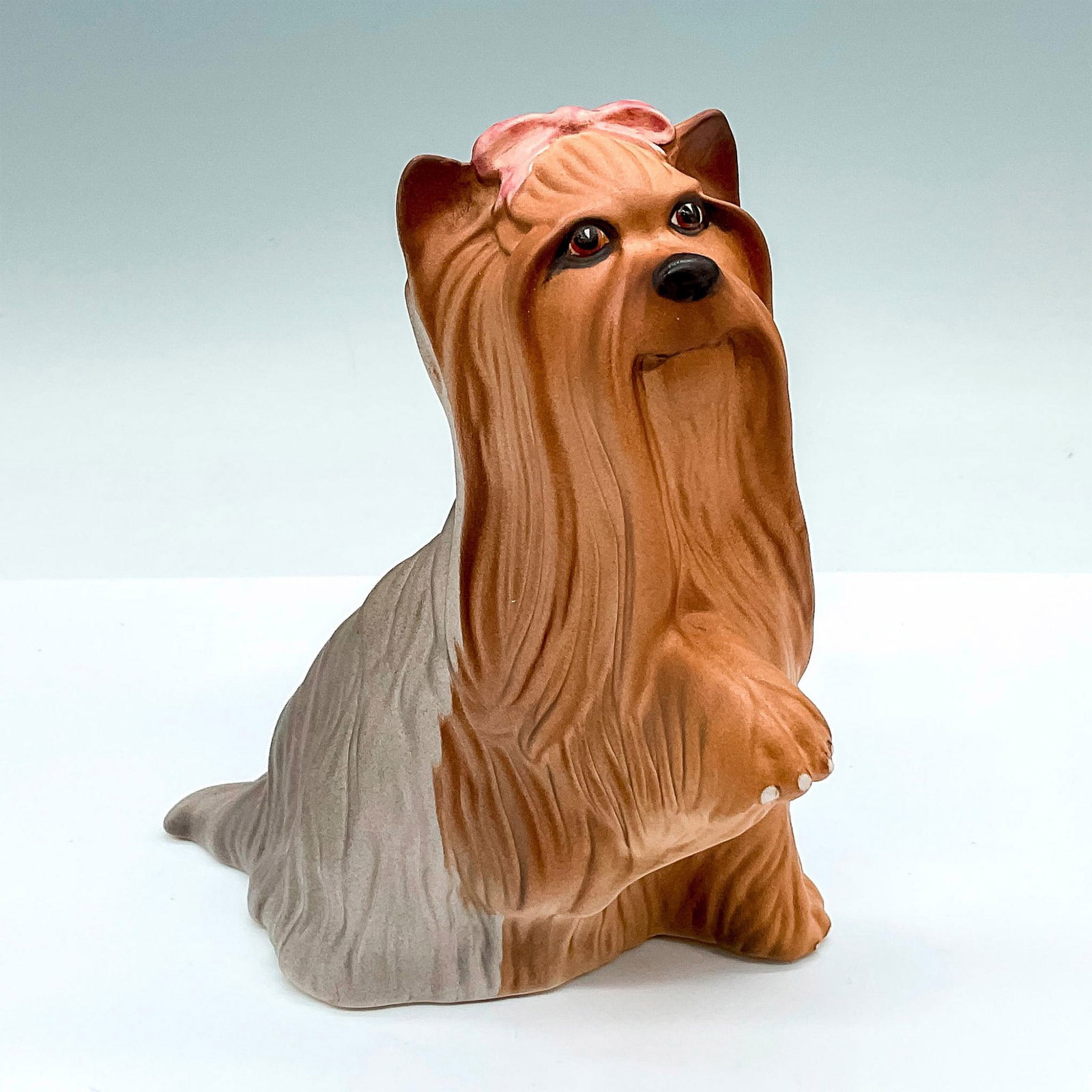 Yorkshire Terrier Seated - Royal Doulton Animal Figure: DA119; Good Companions series; naturalistic dog figure of a light brown and cream matte Yorkshire Terrier. Royal Doulton backstamp. This item has its original box: 8.5"L x 5"W x 3"H. Artist: Warren Pl