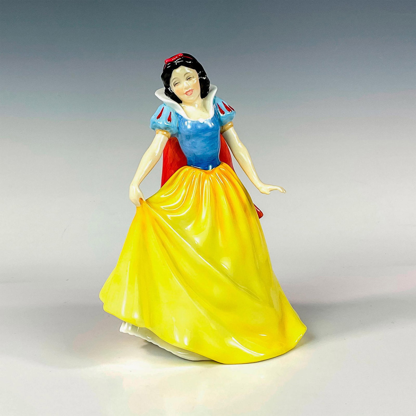 Snow White HN3678 - Royal Doulton Figurine: Limited edition glaze finish; Royal Doulton backstamp. Artist: Pauline Parsons Issued: 1995 Dimensions: 8.25"H Edition Number: 1887 Edition Size: 2000 Manufacturer: Royal Doulton Cou