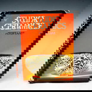 Studio Ceramics, Book by Peter Lane: United Kingdom, William Collins Sons and Co Ltd, 1984. A black hardcover book with the title on the spine in silver lettering along with the original dust jacket. 256-page book about the historical, g